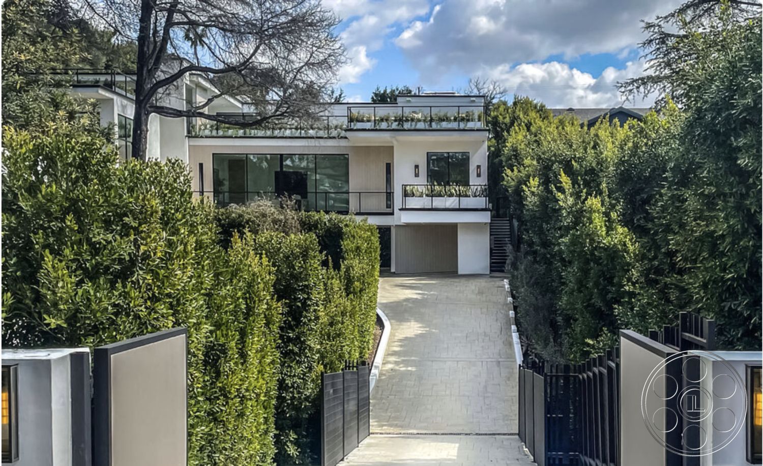 Modern 514 - white stucco walls, panoramic windows, stone pathway, modern two-story home, landscaped garden setting, exterior concrete driveway, contemporary home design, sunny hillside location, wooden gate entrance, curved driveway design, concrete patio border, steel balcony railings, paved driveway surface, glass-paneled front facade, concrete steps to entrance, tropical foliage surrounding, flat roof architectural style, minimalist design features, outdoor terrace area