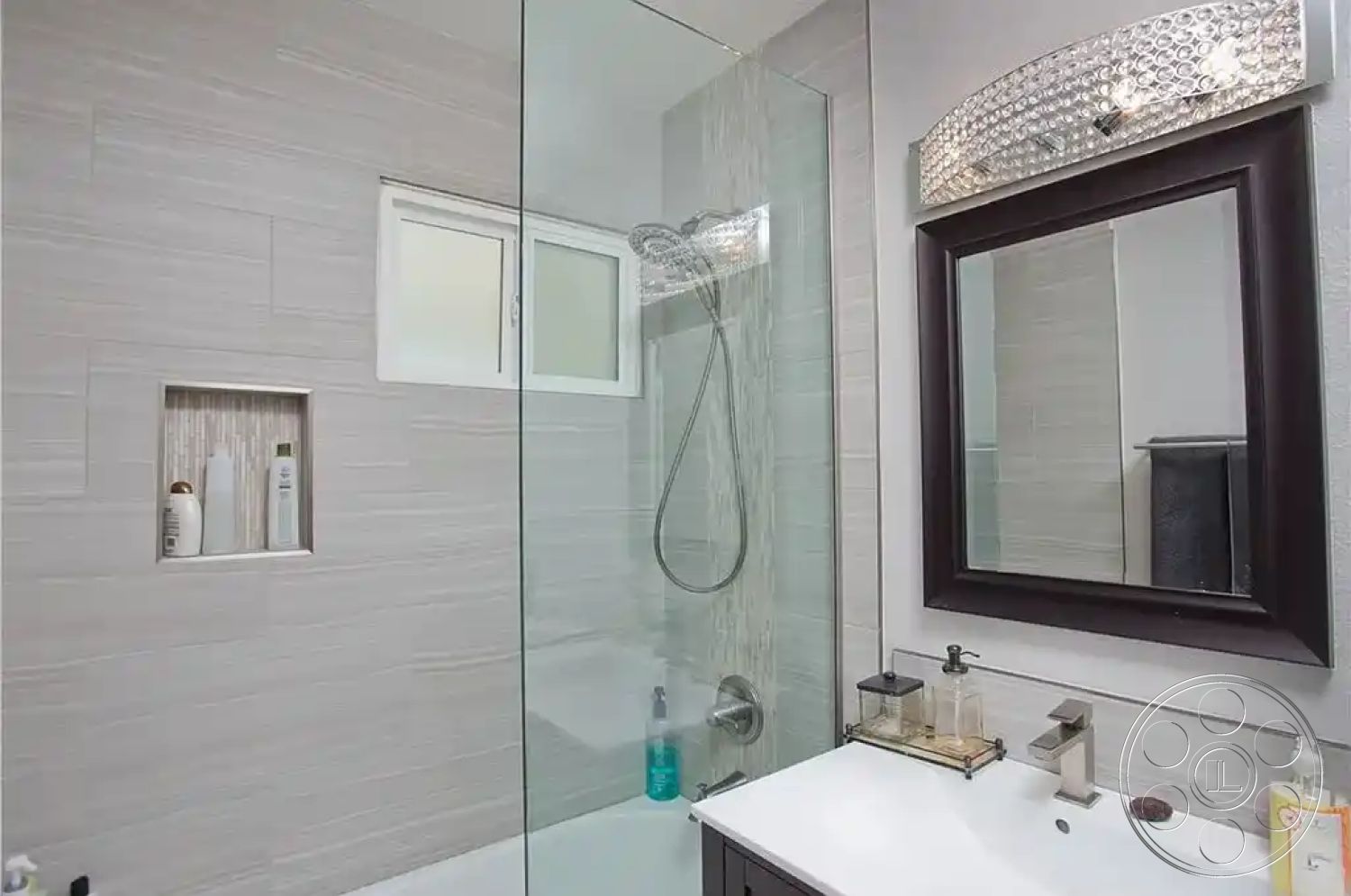 Americana 430 - neutral color palette, minimalist design, glass shower enclosure, textured wall tiles, spa-like atmosphere, contemporary lighting fixture, interior bathroom, chrome faucet fixtures, built-in shower niche, tile bathroom walls, modern sink countertop, dark wood framed mirror