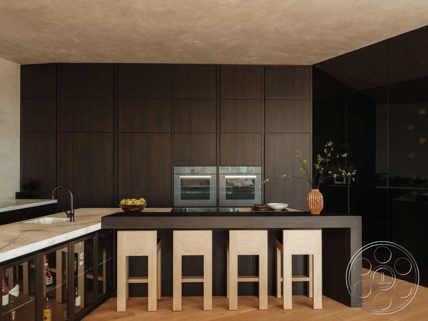 Modern 515 - interior kitchen with dark wood cabinetry, interior kitchen with marble countertop, interior kitchen with hardwood flooring, interior kitchen with minimalist design, interior kitchen with black glass cabinet doors, interior kitchen with wooden bar stools, interior kitchen featuring built-in oven, interior kitchen with textured plaster walls, interior kitchen with modern aesthetic, interior kitchen with decorative vase and plants