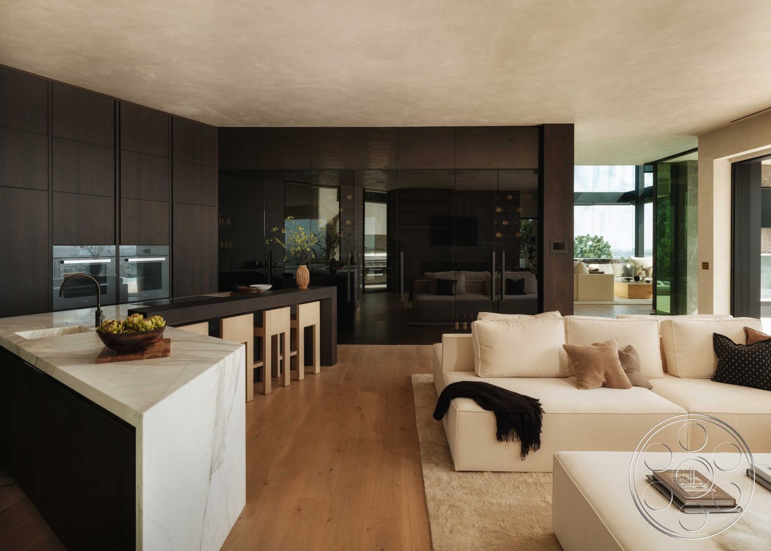 Modern 515 - interior open-concept layout, interior dark wood cabinetry, interior minimalist decor, interior hardwood living room floors, interior marble kitchen island, interior floor-to-ceiling glass doors, interior modern sectional sofa, interior soft area rug, interior stone accent wall, interior contemporary lighting fixtures, interior textured plaster ceiling, interior custom wood bar stools, interior sleek kitchen appliances, interior natural light-filled spaces, interior black glass partition wall