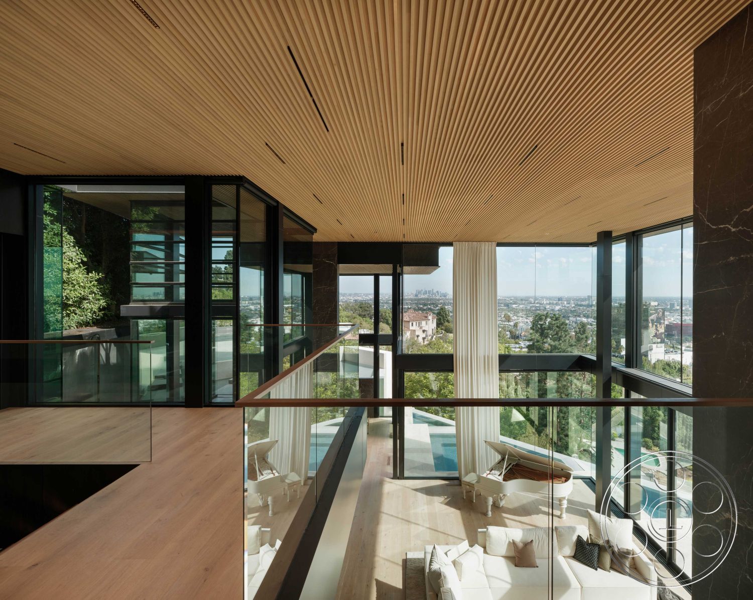 Modern 515 - interior hardwood flooring, exterior landscaped garden view, interior open concept living space, interior minimalist design, interior floor-to-ceiling glass windows, exterior oceanfront view, exterior hillside location, exterior contemporary architecture, interior modern decor, interior seamless indoor-outdoor flow, interior natural light emphasis, interior vertical slat wood ceiling, interior glass railing balcony, interior elegant white sectional sofa, interior polished stone accent wall, exterior infinity pool view