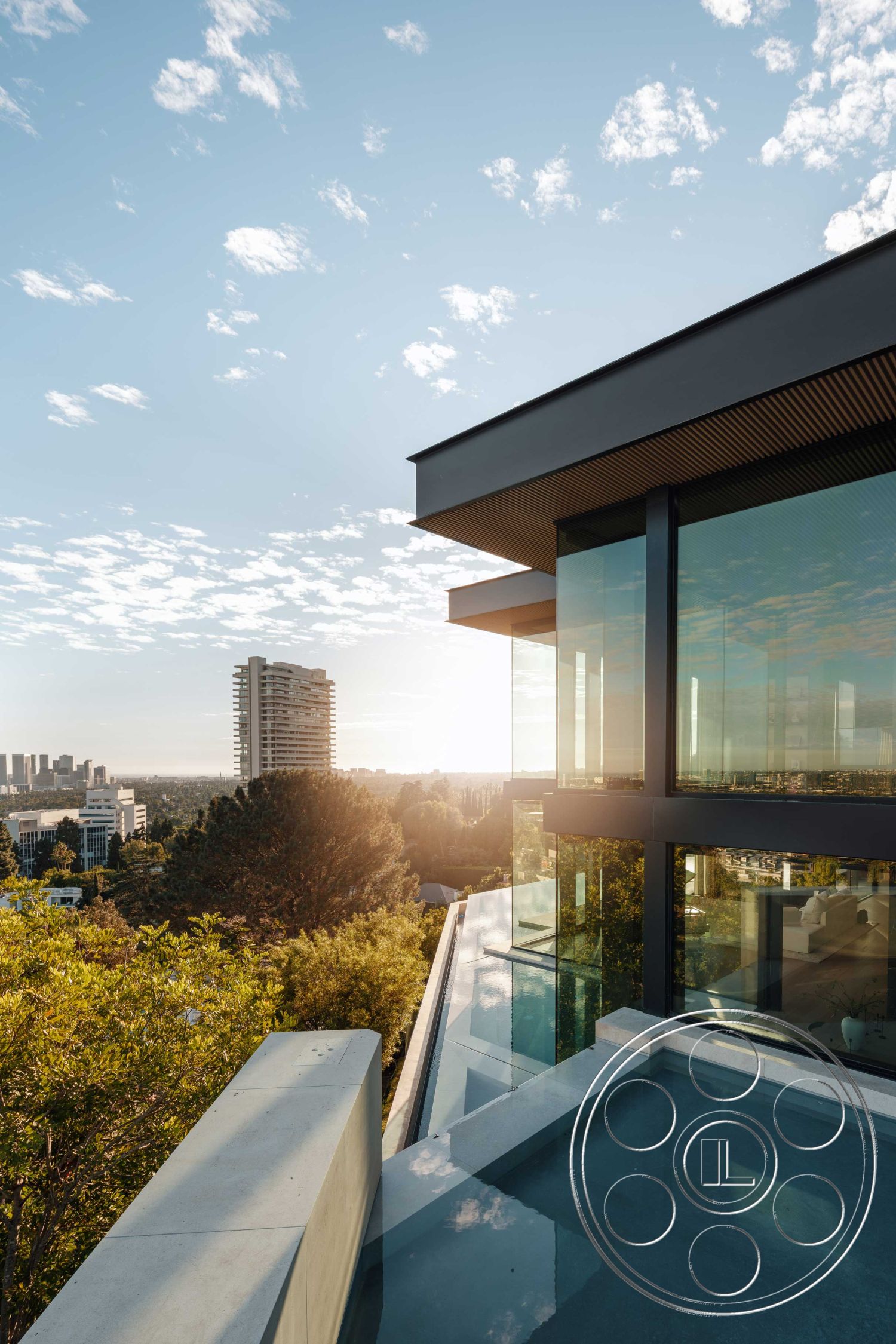 Modern 515 - natural lighting, minimalist design elements, smooth concrete surface, sunset view, steel railing, modern architectural style, open outdoor space, urban skyline view, concrete pool deck, outdoor living area, landscape trees, flat roof design, exposed wood ceiling, exterior landscape setting, elevated hillside location, cantilevered structure, infinity pool edge, glass panoramic windows, concrete balcony edge