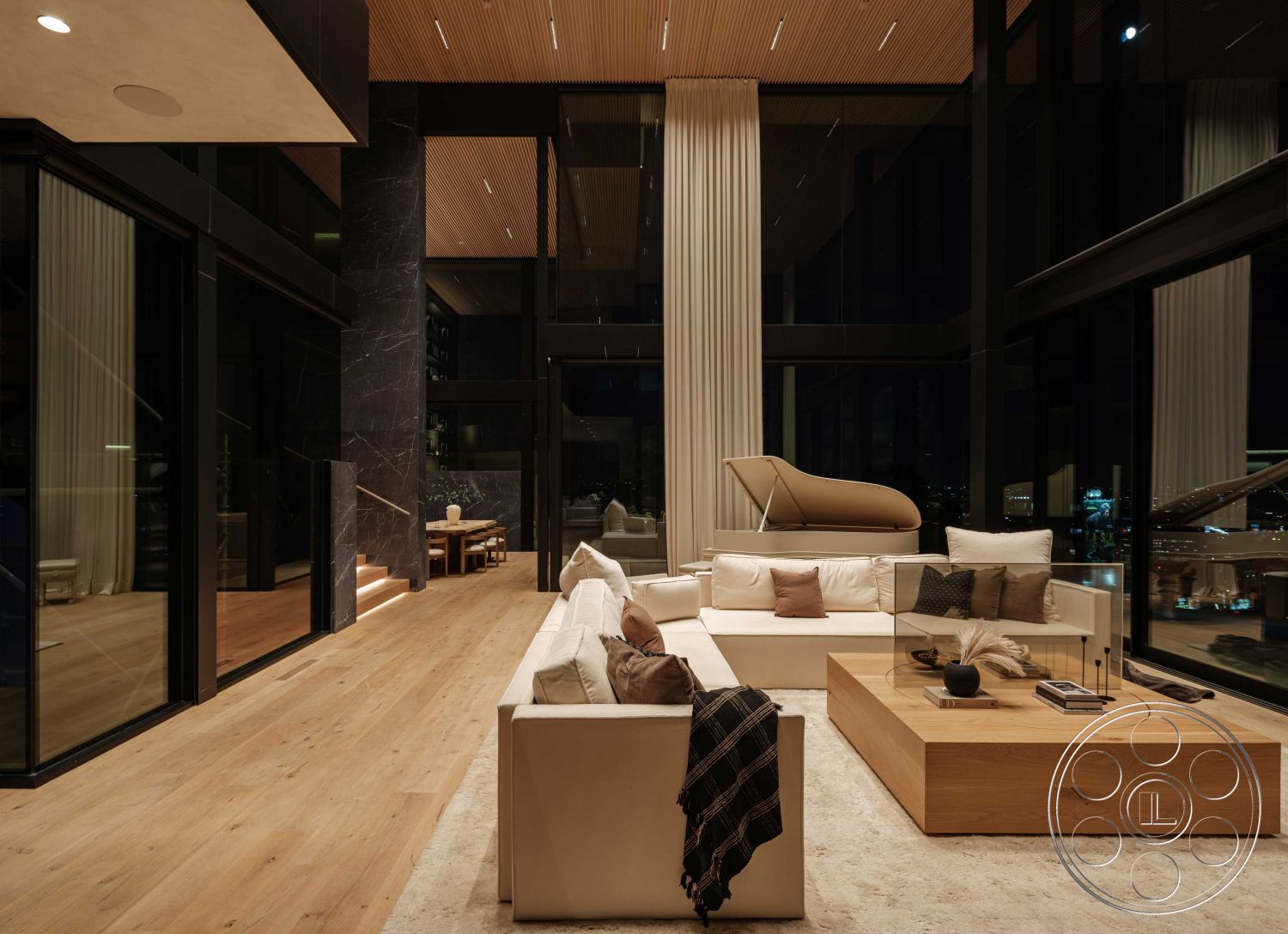 Modern 515 - neutral color palette, floor-to-ceiling windows, soft area rug, minimalist coffee table, hardwood living room floors, interior living room, natural light-filled space, contemporary design style, modern sectional sofa, open-concept interior, vaulted ceiling with wooden beams, dining area with wooden table, exposed wood accents, dark stone feature wall, piano in living area, curtains for light control, city skyline view through windows, stylish decorative pillows