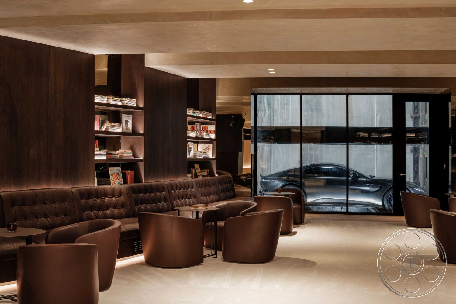 Modern 515 - minimalist decor, polished concrete flooring, contemporary design elements, cozy reading nook, glass partition walls, dark wood paneling walls, built-in shelving units, ambient recessed lighting, interior lounge space, suspended ceiling design, luxury lounge atmosphere, tufted leather seating, industrial-style windows, modern circular bar tables, open urban view, designer armchairs, smooth texture finishes, black frame structural elements, low-profile furniture layout