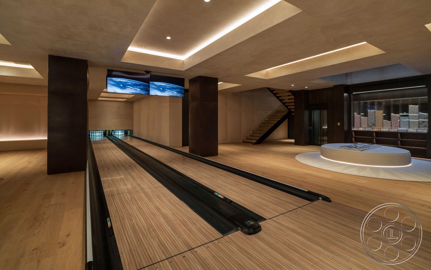 Modern 515 - minimalist design elements, textured plaster walls, dark wood paneling, ambient LED lighting, wide plank hardwood flooring, curved lounge seating, interior bowling alley, floating ceiling with recessed lighting, modern staircase with wooden treads, two-wall-mounted televisions, cozy entertainment area, architectural accent beams, sports-themed decor, multi-functional recreational space