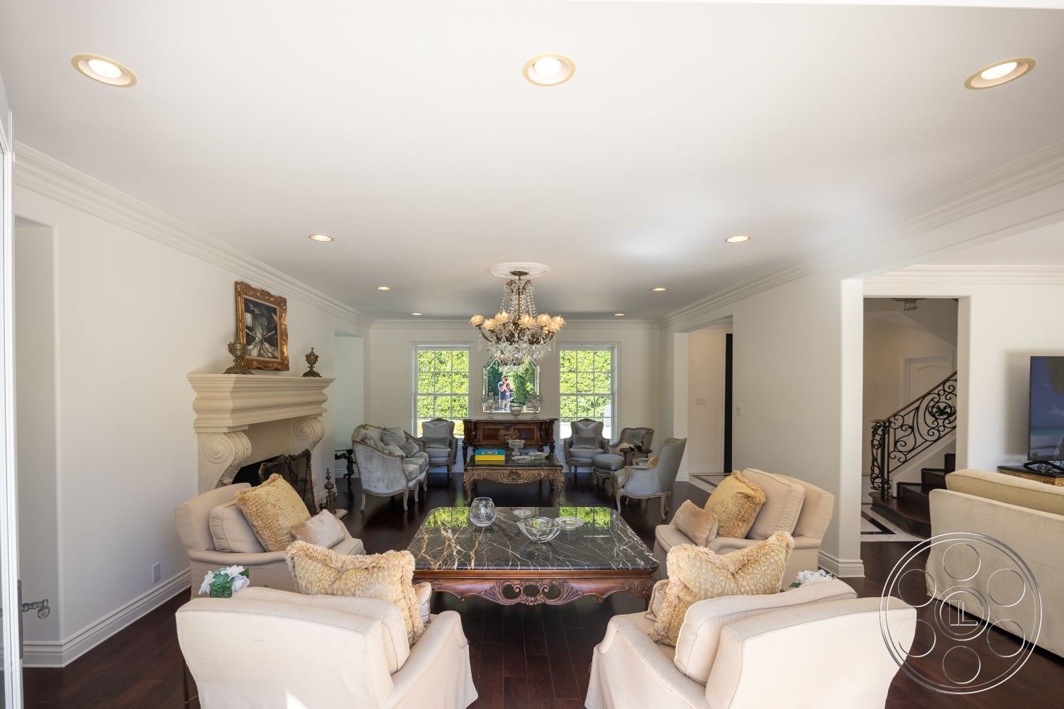 Americana 431 - neutral color palette, floor-to-ceiling windows, sophisticated ambiance, elegant dining area, refined aesthetic, hardwood living room floors, exposed brick fireplace surround, natural light-filled space, open floor plan layout, white painted walls, coffered ceiling details, traditional interior design, elegant chandelier lighting, artwork wall decor, luxurious seating arrangement, detailed crown molding, glass coffee table with marble top, spiral staircase with wrought-iron railings, comfortable seating with decorative pillows, classic interior style