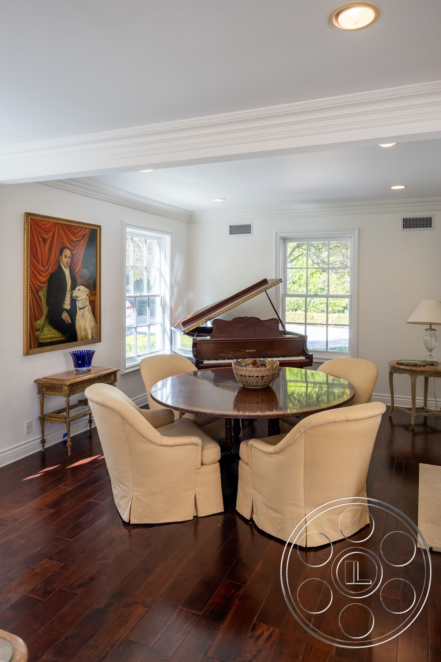 Americana 431 - neutral color palette, cozy reading nook, contemporary interior design, hardwood flooring living room, large windows with natural light, crown molding ceiling details, round dining table interior, spacious interior layout, upholstered armchairs interior, grand piano interior, gallery wall with art, elegant table centerpiece, light fixture recessed lighting, classic home office setting, exposure to garden views