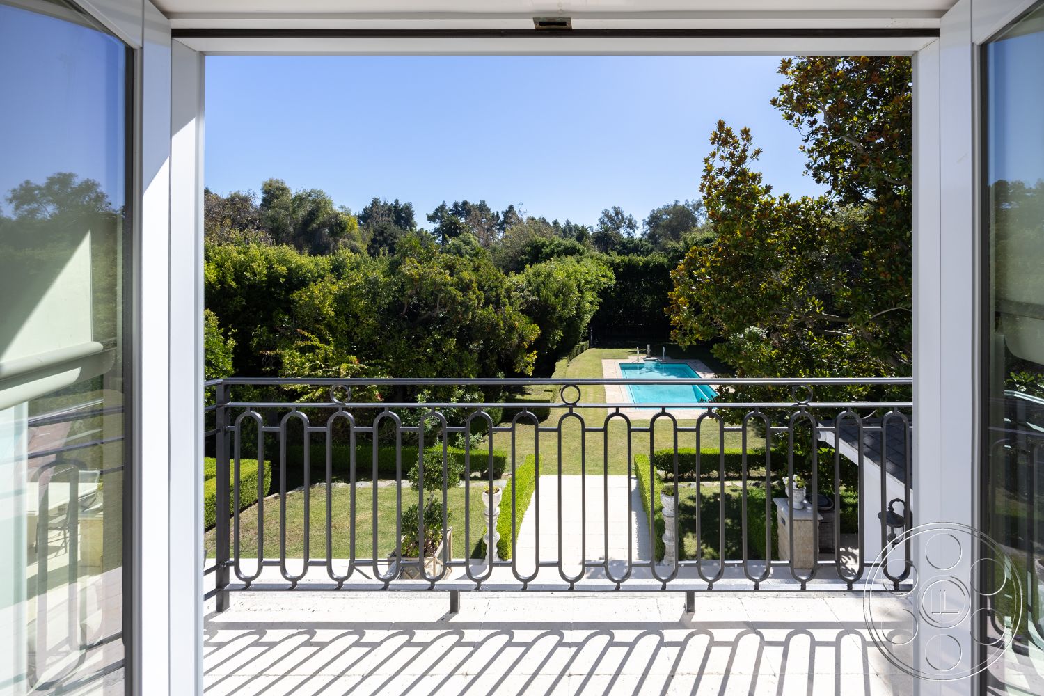 Americana 431 - outdoor living space, modern architectural style, exterior concrete patio floor, exterior sliding glass doors, exterior landscaped garden, garden view setting, exterior paved pathway, exterior rectangular pool, exterior lush greenery, exterior stone steps, exterior manicured hedges, exterior metal railing balcony, exterior white framed windows