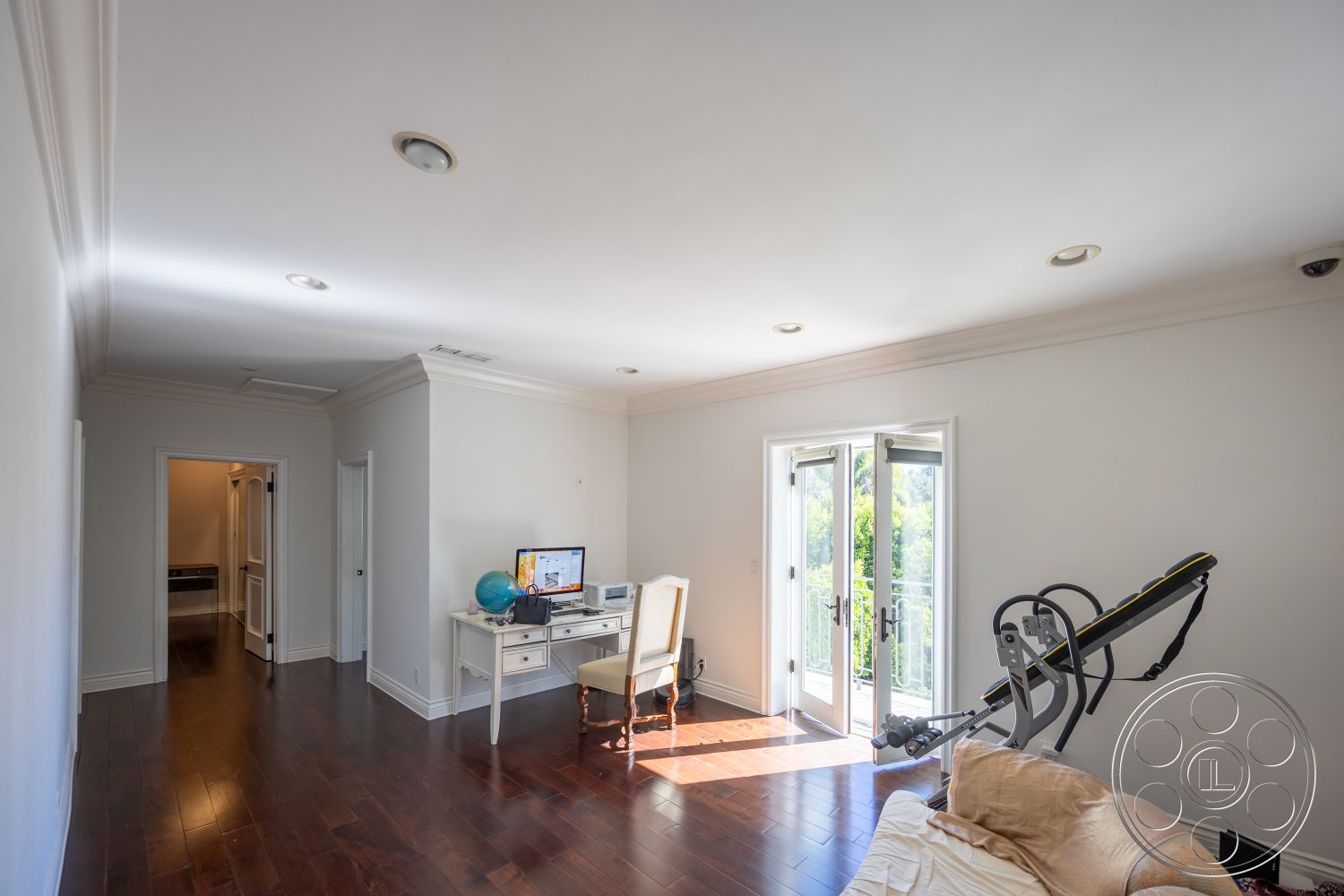 Americana 431 - neutral color palette, natural light, hardwood flooring, recessed lighting, open layout, modern design, fitness equipment, double French doors, contemporary interior, white painted walls, crown molding details, interior room, office desk setup, suburban home office