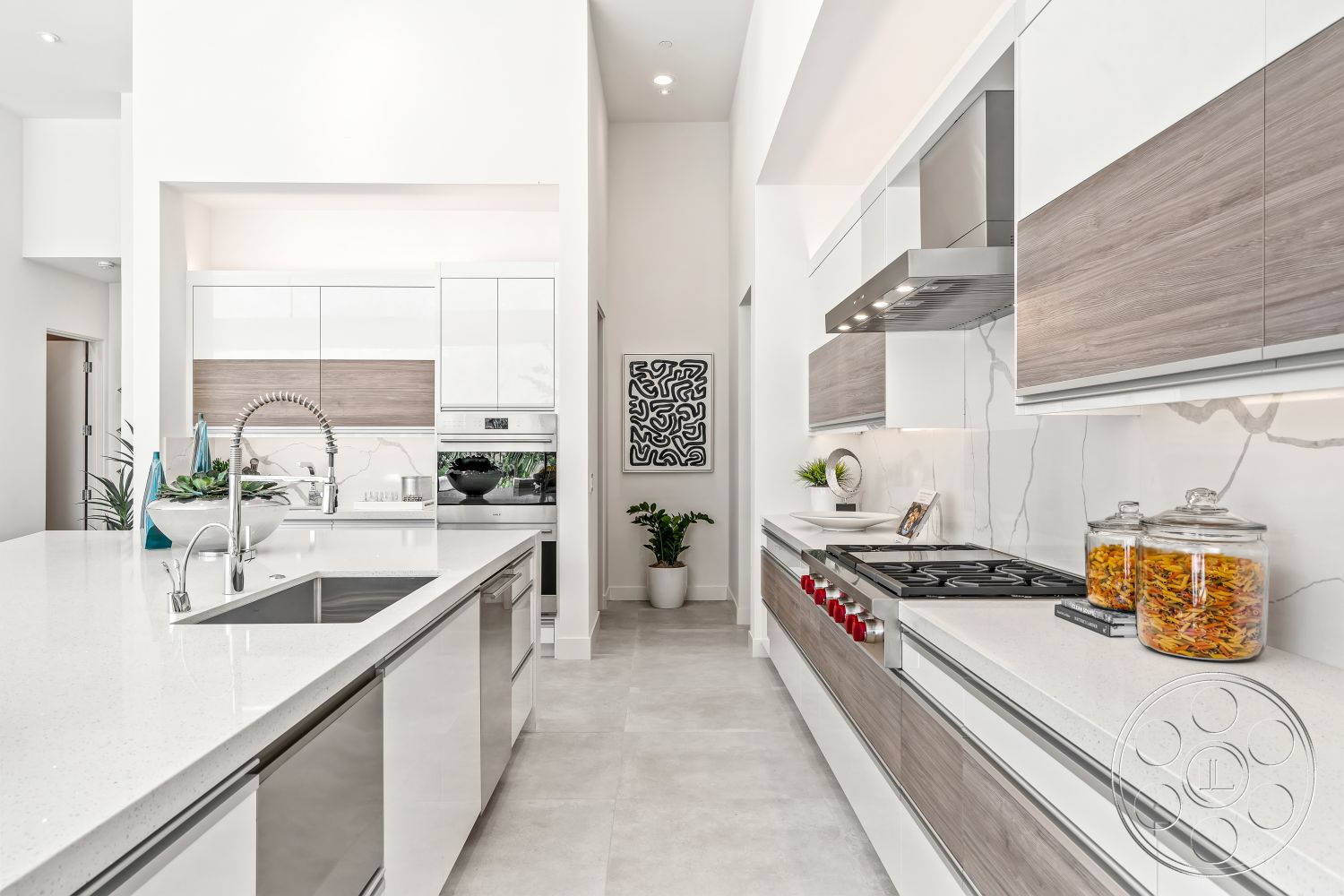 Palm Springs 109 - stainless steel kitchen appliances, open kitchen layout, interior kitchen design, high ceilings with recessed lighting, light gray concrete flooring, open shelving for kitchen storage, high-gloss white cabinetry, quartz countertop with waterfall edge, laminate wood cabinet fronts, modern kitchen backsplash with marble detail, contemporary kitchen sink with pull-down faucet, minimalist kitchen faucet, double wall oven built into cabinetry, floor-to-ceiling kitchen cabinets, chrome cabinet hardware, induction cooktop with stainless steel hood, decorative wall art above kitchen counter, potted plants for kitchen decor, spacious kitchen island for food preparation