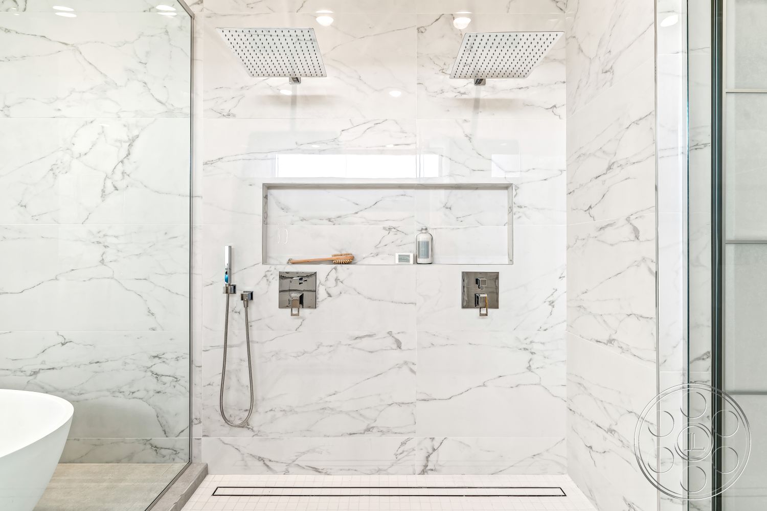 Palm Springs 109 - interior marble shower walls, interior polished marble flooring, interior chrome faucet fixtures, interior contemporary lighting fixtures, interior marble accent wall, interior minimalist bathroom design, interior modern bathroom, interior frameless glass shower enclosure, interior rain showerhead fixture, interior built-in shower shelf, interior linear shower drain, interior under-mounted bathtub