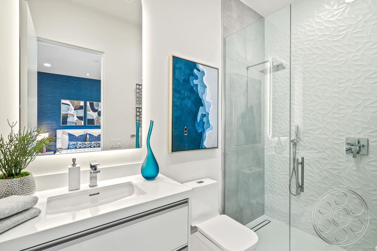 Palm Springs 109 - natural light from window, glass shower doors, minimalist bathroom design, contemporary bathroom decor, textured plaster bathroom walls, floating bathroom vanity, white porcelain floor tiles, framed mirror with LED lighting, blue accent wall, modern sanitary ware, stylish shower fixtures, greenery decor in bathroom