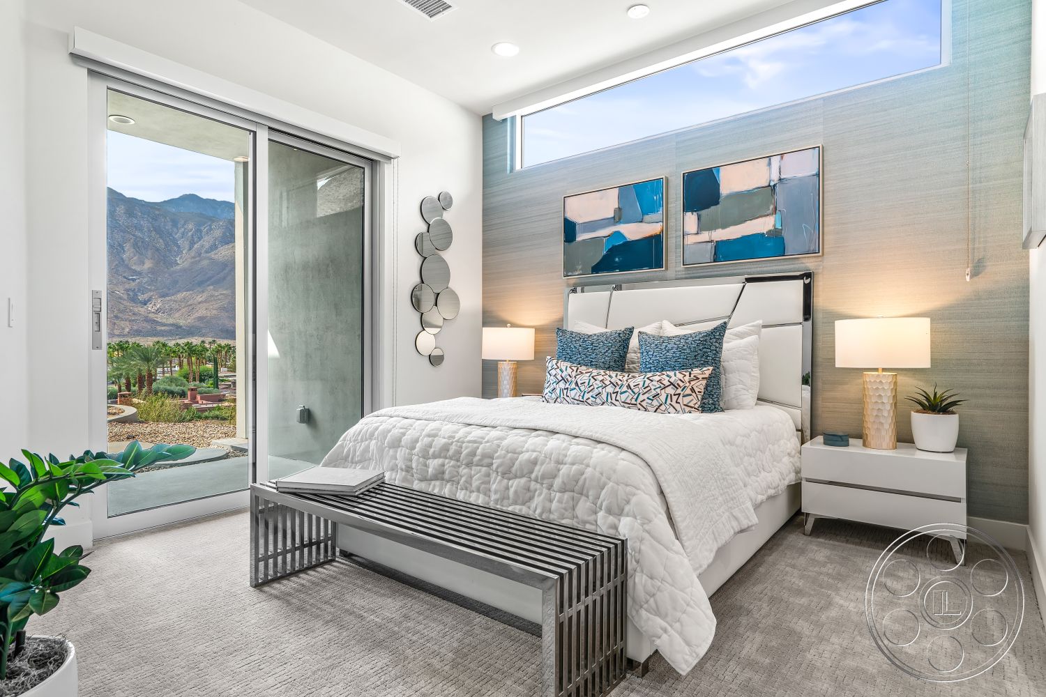 Palm Springs 109 - textured wallpaper accent wall, large windows with natural light, interior bedroom with plush carpet flooring, modern white upholstered bed frame, decorative throw pillows with geometric patterns, sliding glass door with mountain view, contemporary bedside tables with lamps, decorative wall art with abstract design, stylish metal bench with sleek lines, indoor plants for a fresh ambiance, open floor plan with seamless indoor-outdoor flow, soft white bedding with a quilted pattern, minimalist decor with clean lines, soft, neutral color palette, elegant lighting fixtures with modern design