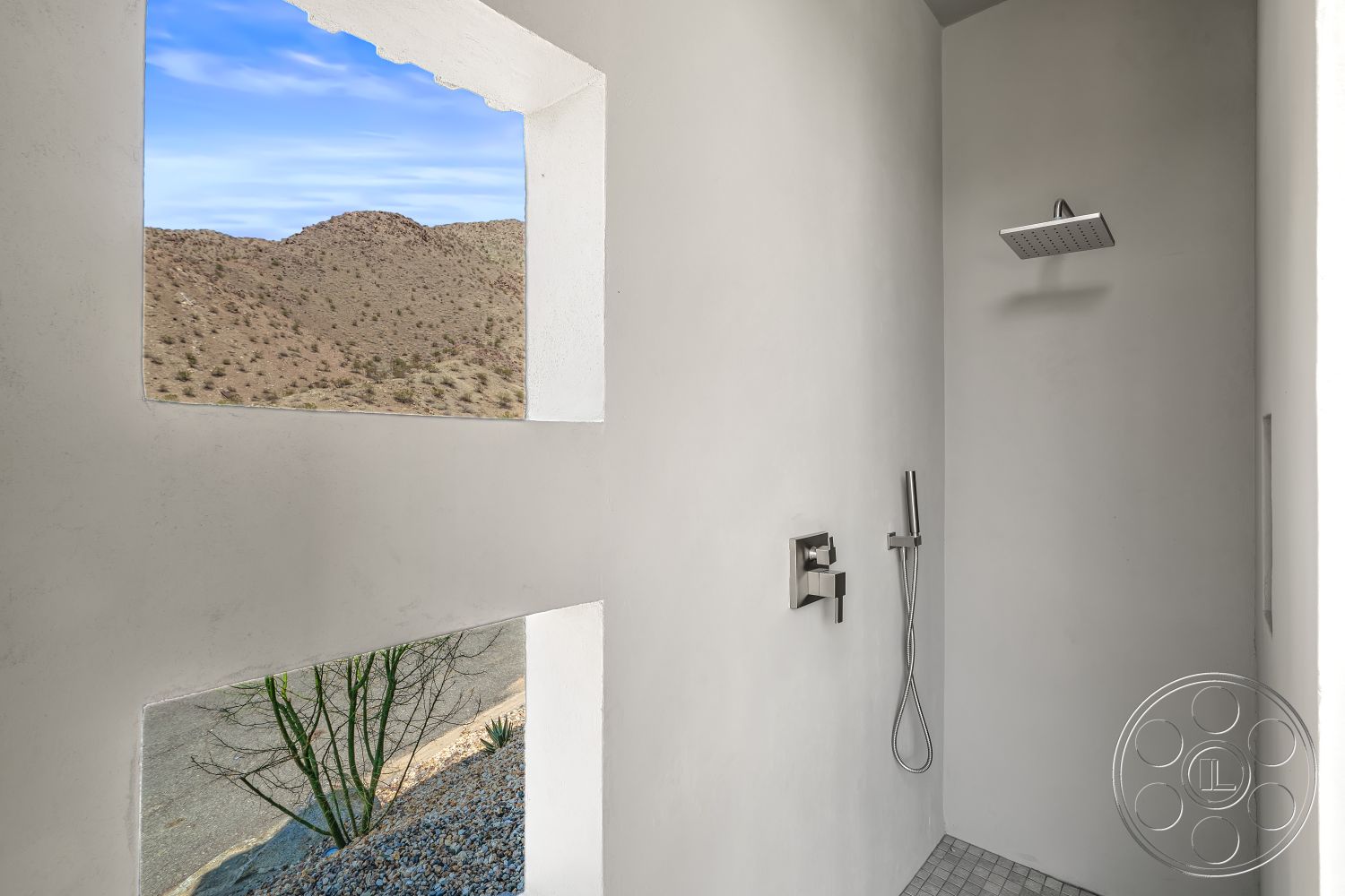 Palm Springs 109 - chrome shower fixtures, white textured plaster walls, exterior mountain view, desert home setting, porcelain tile shower floor, minimalist shower design, glass shower head, open-concept shower space, interior shower area, angled window frames
