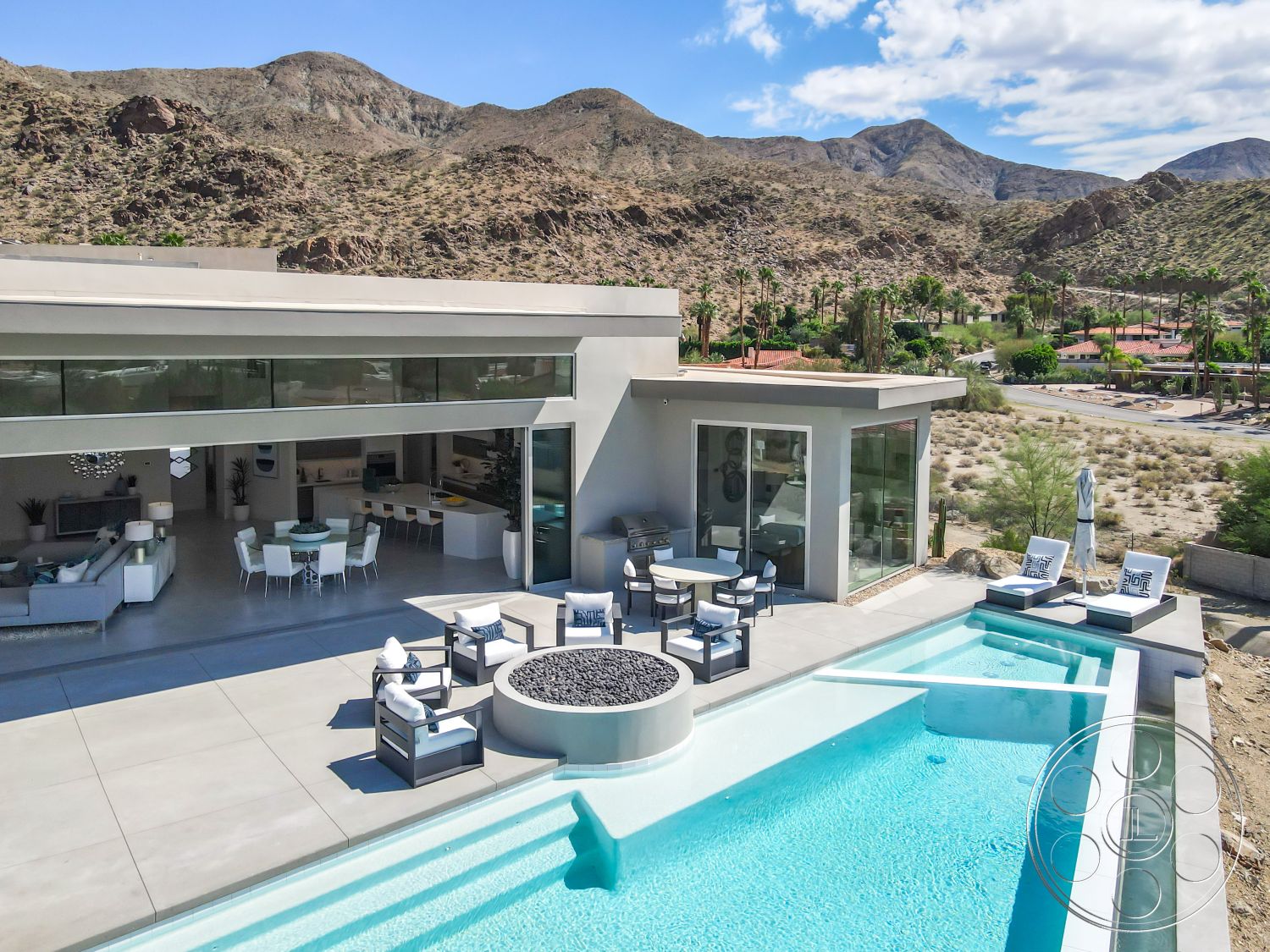 Palm Springs 109 - exterior landscaped garden area, interior minimalist furniture design, interior open concept living space, exterior glass sliding doors, exterior concrete pool deck, interior polished concrete floors, exterior rectangular infinity pool, exterior concrete patio flooring, interior sleek cabinetry, interior vaulted ceiling with recessed lighting, interior modern dining room, interior lounge area with sectional sofa, exterior modern outdoor seating area, interior large windows with mountain views, interior contemporary kitchen area, interior white open space with natural lighting, exterior desert landscape setting, exterior outdoor fire pit feature, exterior stone accent wall, exterior terraced backyard
