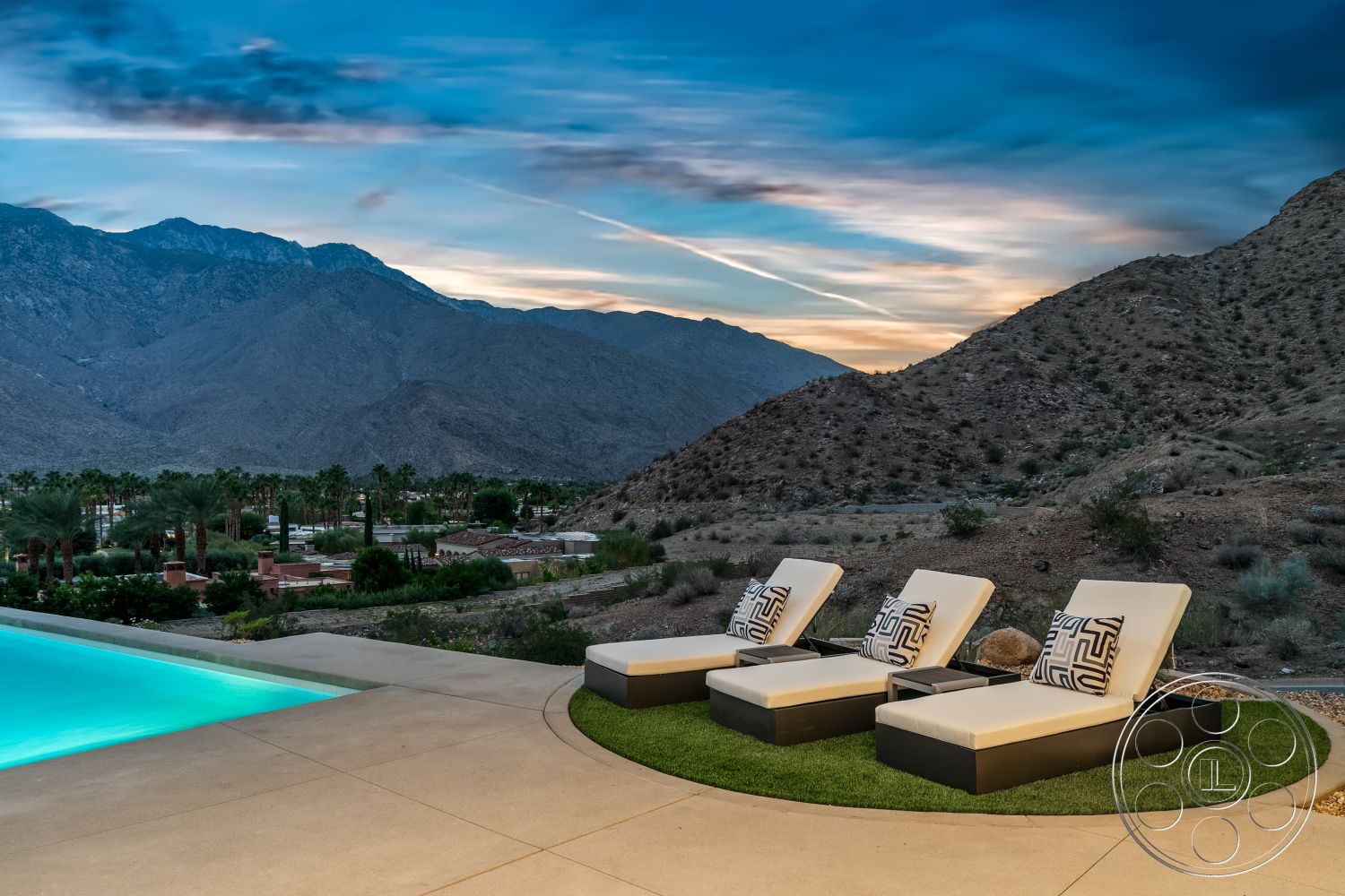 Palm Springs 109 - mountain view, sunset sky, contemporary outdoor space, desert setting, rectangle swimming pool, landscaped garden area, concrete pool border, palm tree landscape, textured concrete patio flooring, modern outdoor lounge chairs, exterior pool deck, sloped mountainous backdrop, green grass area