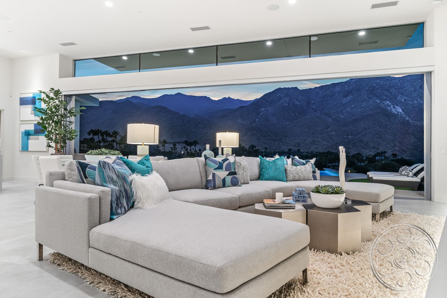 Palm Springs 109 - neutral color palette, textured area rug, smooth wall finishes, soft lighting fixtures, minimalist coffee table, large floor-to-ceiling windows, decorative throw pillows, open concept living area, modern sectional sofa, interior concrete flooring, indoor plant accents, contemporary wall art, mountain view backdrop, designer table lamps, spacious living room layout