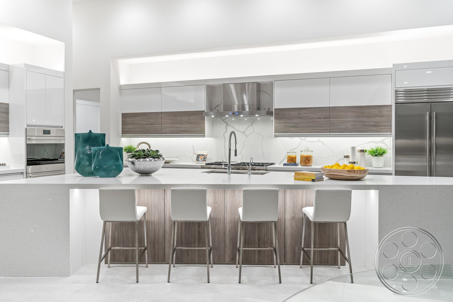 Palm Springs 109 - interior kitchen with pendant lighting, interior kitchen with minimalist design, interior kitchen with stainless steel appliances, interior kitchen with bar seating, interior kitchen with open concept layout, interior kitchen with white quartz countertops, interior kitchen with high-gloss white cabinetry, interior kitchen with wood laminate lower cabinets, interior kitchen with glass backsplash, interior kitchen with modern faucet fixtures, interior kitchen with under-cabinet lighting, interior kitchen with tiled floor, interior kitchen with decorative fruit bowl, interior kitchen with lush green plants