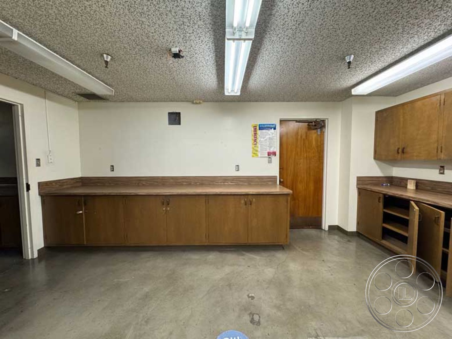 School 3 - minimalist design, open layout, wood cabinetry, storage cabinets, concrete flooring, laminate countertops, interior workspace, fluorescent ceiling lighting, double-door entry, textured acoustic ceiling, service room, functional utility space