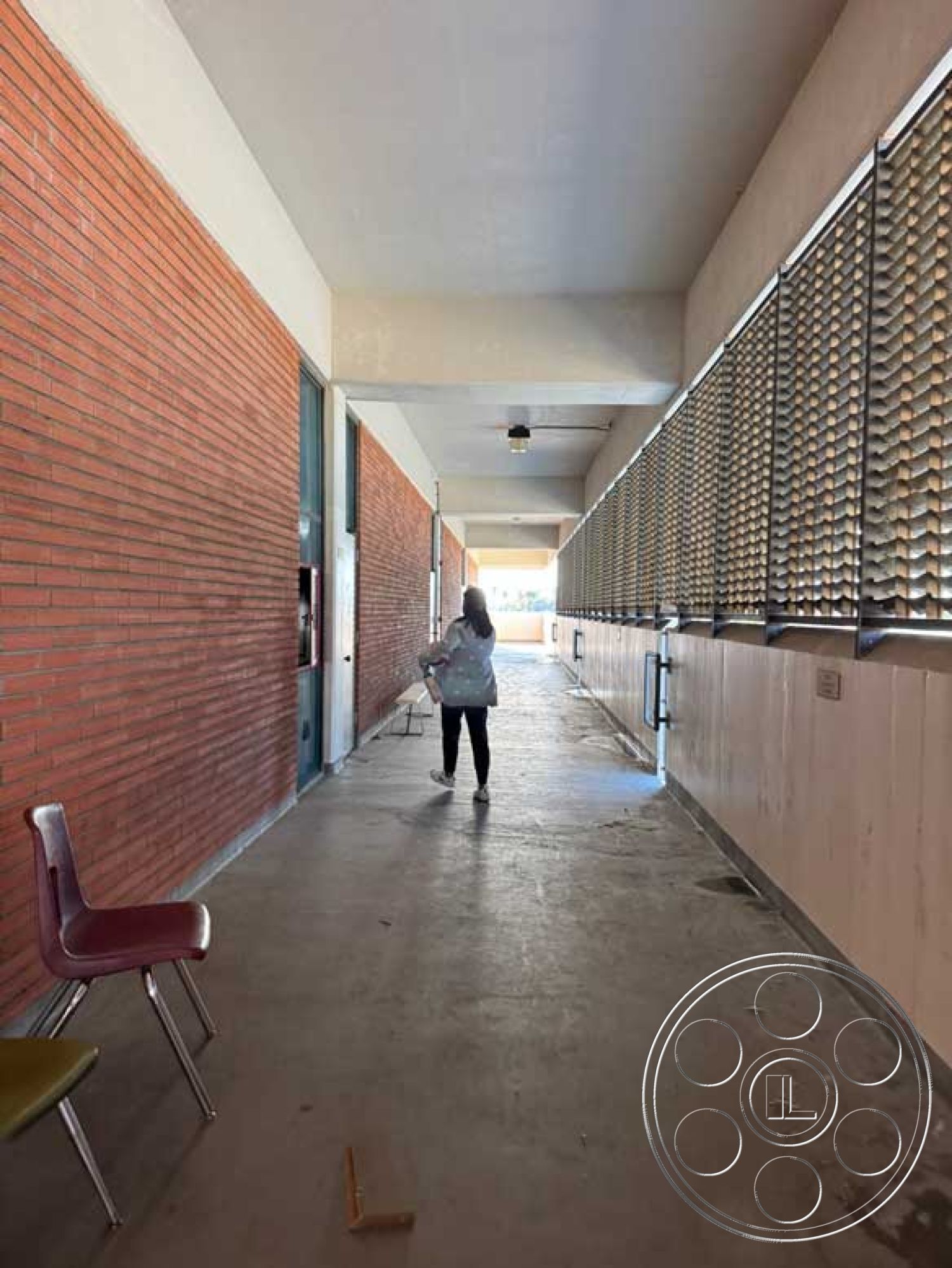 School 3 - natural light exposure, straight hallway layout, suspended ceiling fixtures, exposed brick corridor walls, concrete walkway flooring, metal screening window treatments, modern minimalist ceiling, industrial hallway design, interior school corridor, seating area with metal chairs