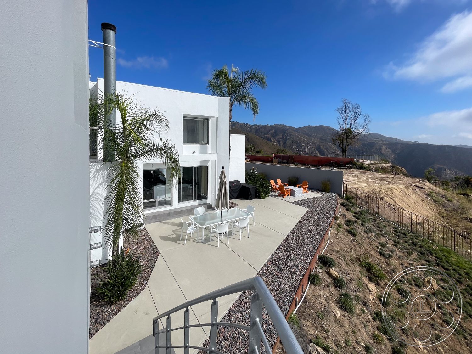 Modern 56 - modern outdoor furniture, desert landscape, flat roof design, mountain view setting, urban hillside location, landscaped garden beds, rectangular patio layout, concrete patio floor, white stucco exterior walls, interior modern decor, glass sliding patio doors, exposed aggregate border