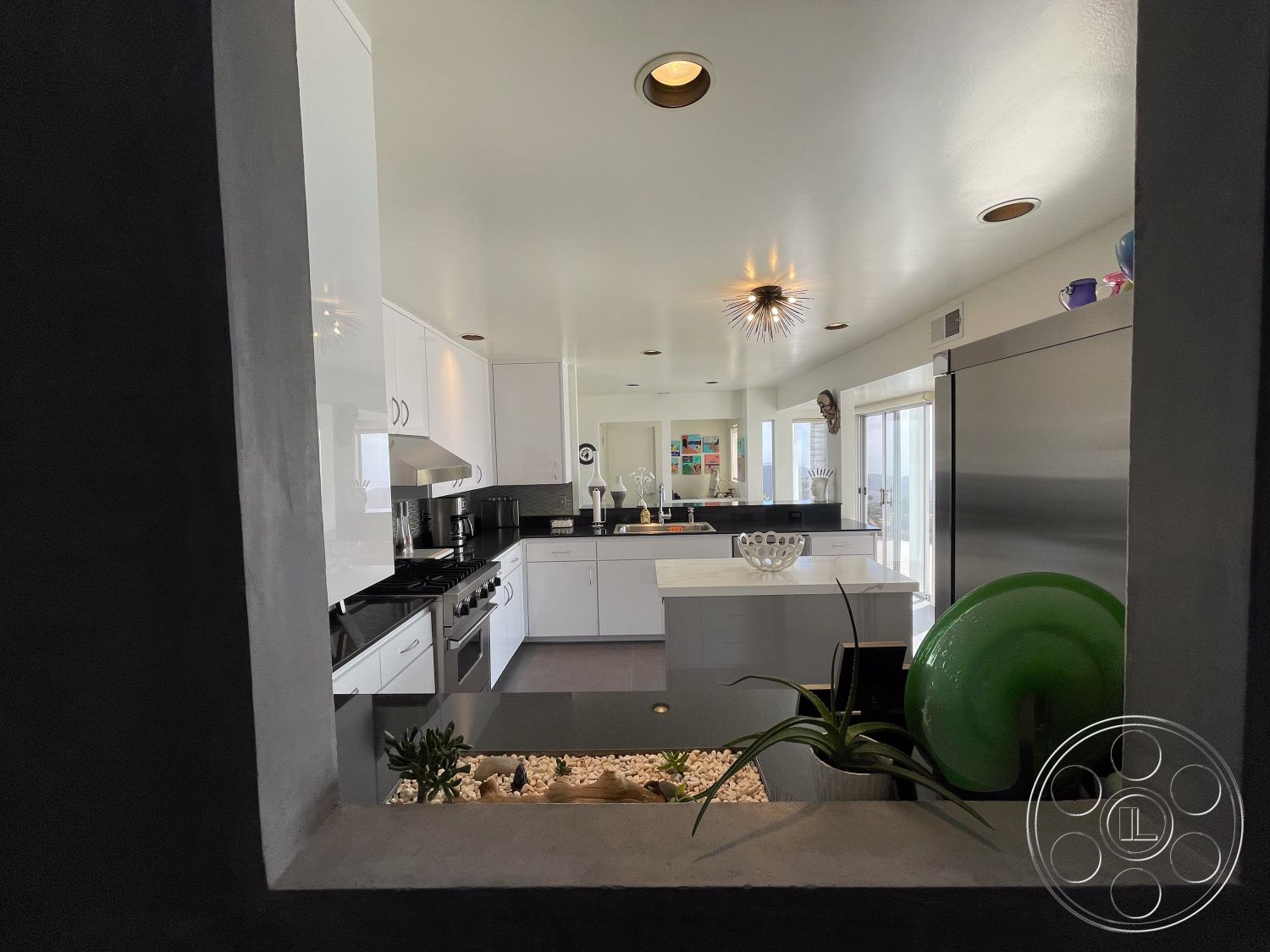 Modern 56 - interior textured plaster wall, interior modern pendant lighting, interior minimalist decor, interior open floor plan, interior contemporary design elements, interior recessed ceiling lights, interior stainless steel appliances, interior glass window wall, interior artistic wall decor, interior kitchen with white laminate cabinetry, interior black granite countertop, interior sleek kitchen island, interior integrated sink, interior indoor plants arrangement, interior decorative stone features, interior seamless layout