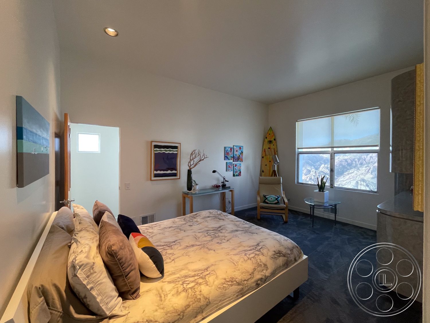 Modern 56 - neutral color palette, wooden door, textured plaster walls, decorative throw pillows, interior bedroom, minimalist decor style, soft textile bedding, modern bed frame, natural lighting from window, marble bedroom flooring, glass bedside table, creative wall art, mountain view through window, beach-themed decor, chair with modern design, contemporary surfboard decor, functional workspace corner, light fixtures with recessed lights