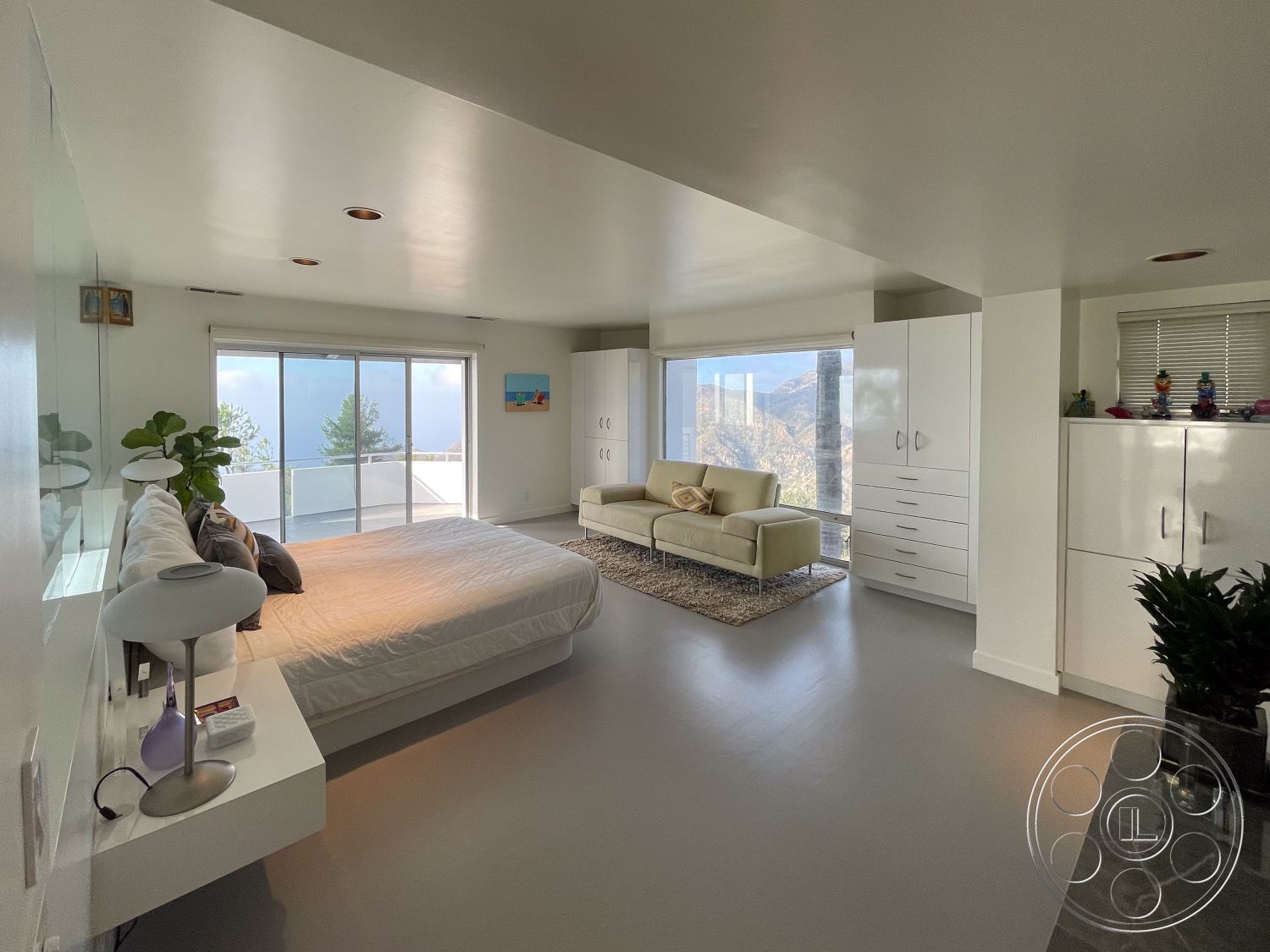 Modern 56 - suburban setting, floor-to-ceiling windows, city skyline view, light gray flooring, soft lighting fixtures, built-in cabinetry, white painted walls, minimalist furniture design, outdoor balcony access, modern master bedroom interior, contemporary platform bed, sleek modern sofa, decorative throw rug
