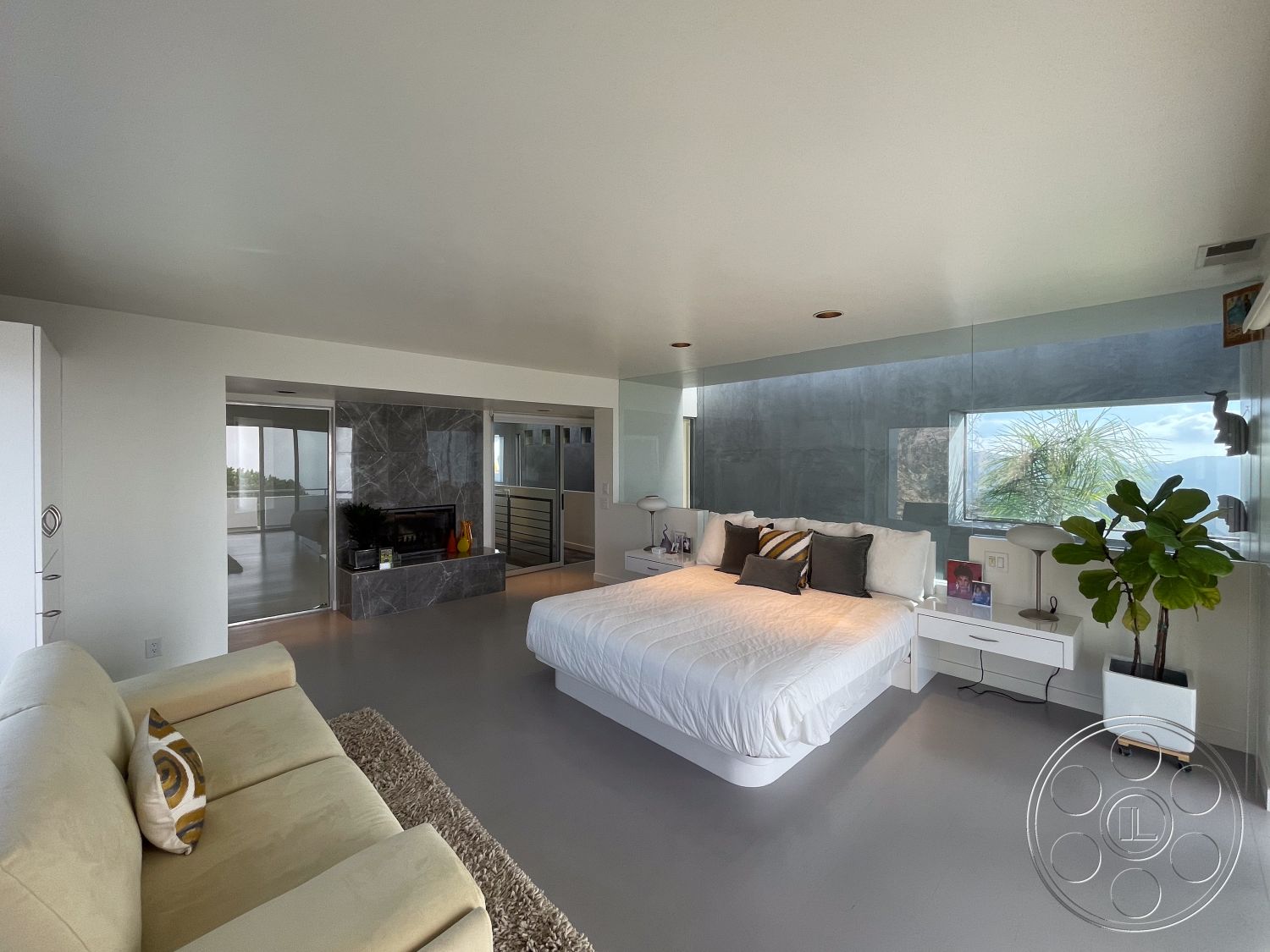 Modern 56 - ceiling-mounted lighting fixtures, exposed ceiling with recessed lighting, modern accent pillows, contemporary platform bed, interior bedroom with minimalist decor, smooth polished concrete flooring, glass wall with scenic view, marble feature wall with fireplace, white upholstered bedding, floating nightstands with minimalistic design, potted plants for interior greenery, open layout with natural light influx, neutral color palette with soft textures, luxury minimalism aesthetic