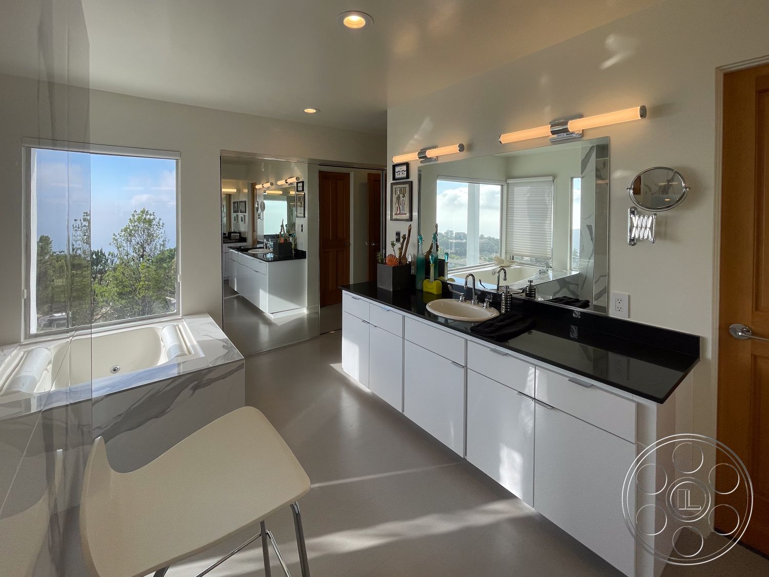 Modern 56 - open layout, glass shower enclosure, floor-to-ceiling windows, neutral wall color, black granite countertop, interior bathroom design, high-contrast color scheme, luxury spa-like atmosphere, minimalist lighting fixtures, smooth polished concrete flooring, white glossy cabinetry, large corner bathtub, contemporary bathroom mirrors, modern stool seating, view of urban landscape