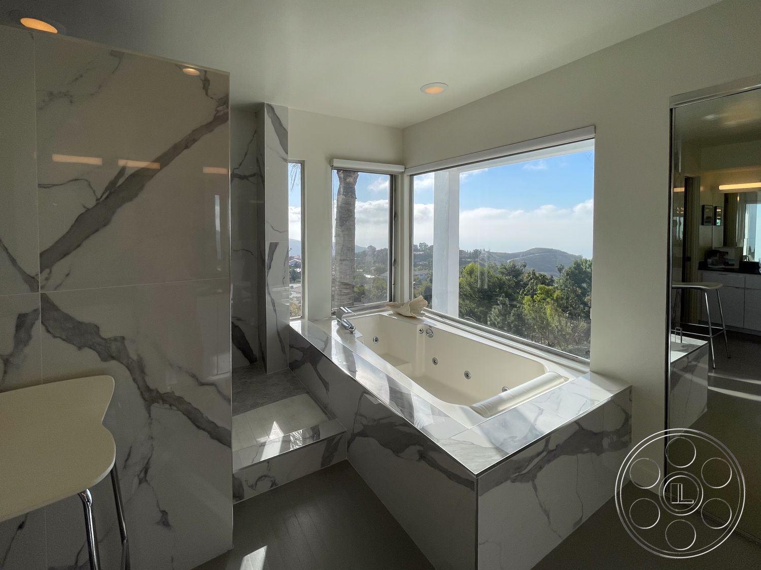 Modern 56 - interior recessed ceiling lights, interior marble bathroom walls, interior glass shower enclosure, interior marble bathtub surround, interior minimalistic decor, interior neutral painted walls, interior contemporary bathroom fixtures, interior porcelain bathroom flooring, interior modern angular design, interior large window with panoramic view, interior soaking tub with jets, interior chrome bathroom fixtures, interior polished stone accents, interior light gray cabinetry, interior seamless transition to living space