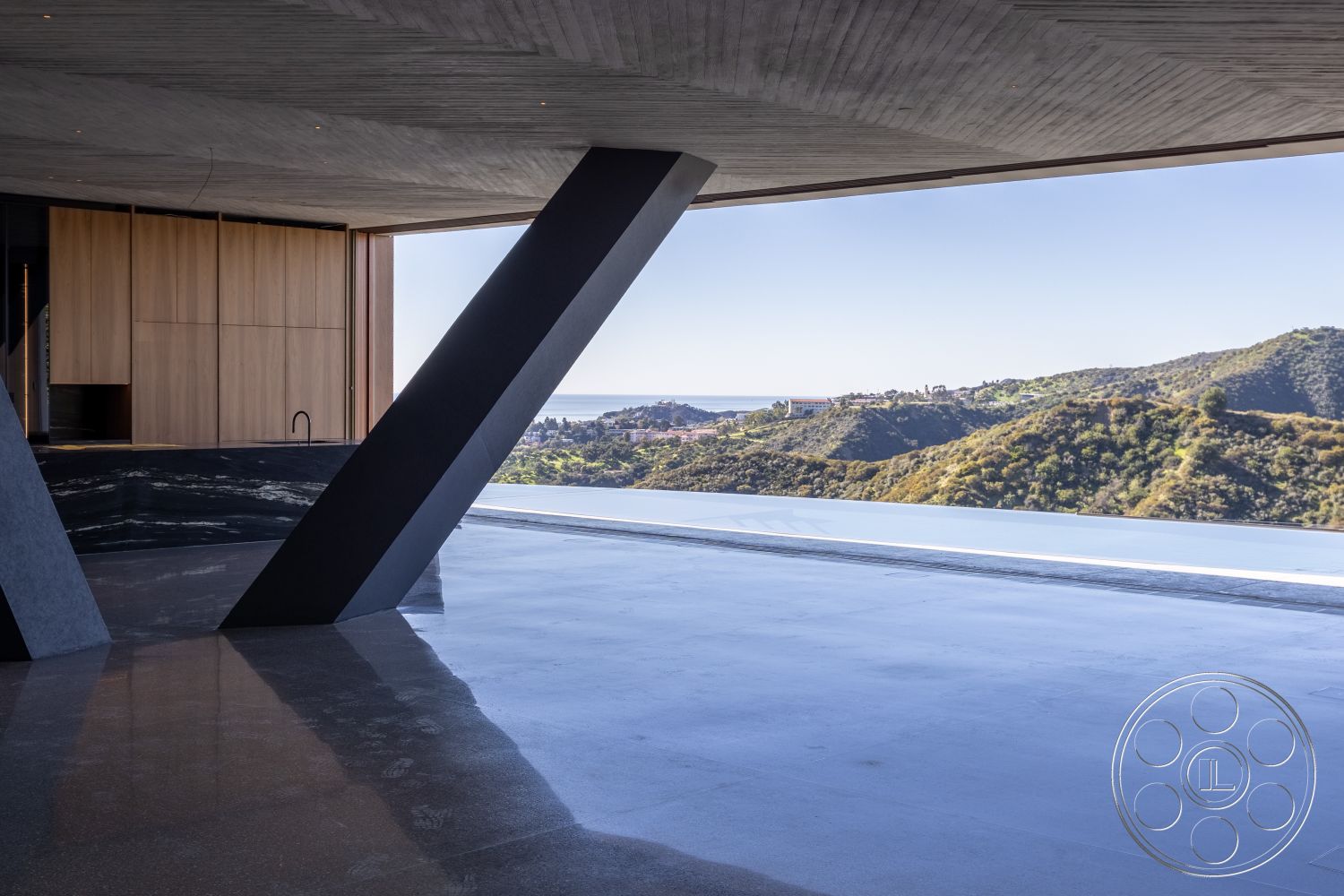 Modern 516 - seamless indoor-outdoor transition, contemporary architectural style, modern minimalist design, floor-to-ceiling windows interior, open floor plan interior, natural light emphasis, exposed concrete walls interior, large sliding glass doors interior, wood panel accent wall interior, polished concrete flooring interior, steel structural columns interior, geometric shapes architecture, hillside location exterior, ocean view interior, integrated cabinetry interior, textured surface finishes