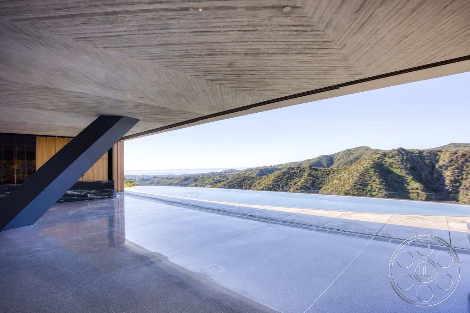 Modern 516 - polished concrete flooring, minimalist design elements, contemporary architectural style, floor-to-ceiling glass windows, exterior concrete walls, textured concrete ceiling, landscape setting, framed mountain view, outdoor infinity pool, cantilevered overhangs, modern pool edge, wood veneer wall panels, angular structural supports, open outdoor terrace, seamlessly integrated indoor-outdoor flow