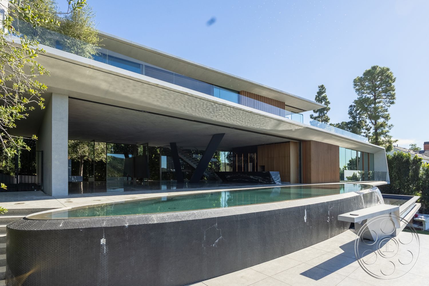 Modern 516 - minimalist design elements, seamless indoor-outdoor transition, outdoor lounge area, sustainable materials, curved swimming pool, contemporary architectural style, urban hillside location, floor-to-ceiling glass windows, geometric shapes in architecture, exterior glass walls, exterior wooden accents, exterior concrete structure, rectangular pool deck, textured concrete pool border, modern patio flooring, slate tile patio, exposed concrete ceilings, landscape with greenery, pool area with water feature