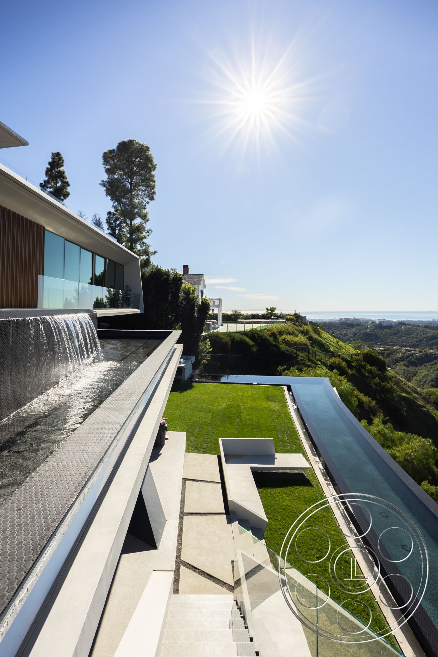 Modern 516 - exterior landscaped garden, interior floor-to-ceiling windows, interior wood beam ceiling, interior minimalist design, exterior glass railing, exterior infinity pool, exterior outdoor seating area, exterior concrete steps, exterior concrete patio flooring, exterior aluminum window frames, exterior stone waterfall feature, exterior rectangular lawn area, exterior views of hillside landscape, exterior geometric modern architecture, exterior stainless steel pool border, interior sleek contemporary style