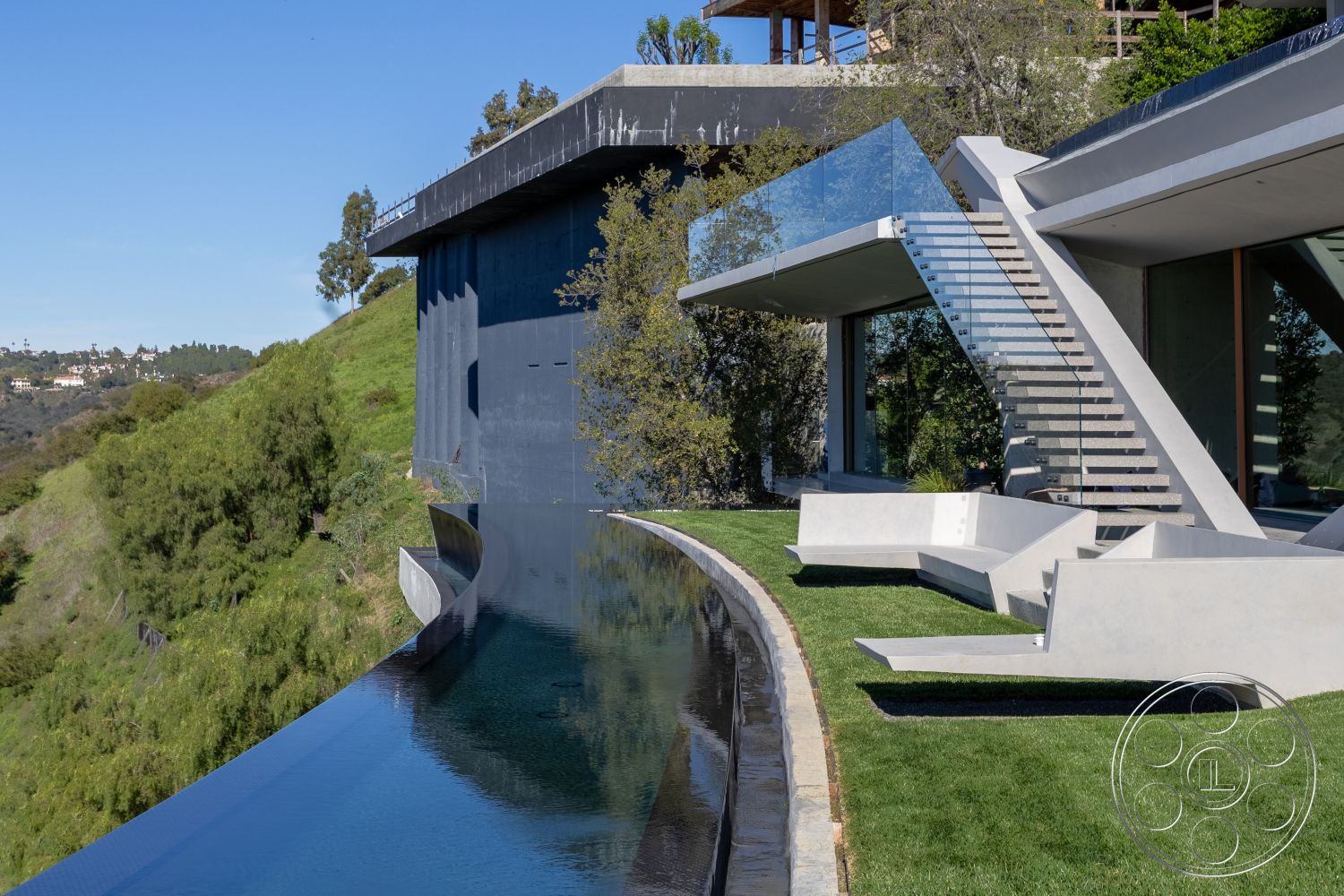 Modern 516 - interior floor-to-ceiling windows, exterior stone pathway, interior open-concept design, interior exposed concrete walls, exterior infinity pool, setting hillside location, interior natural light emphasis, exterior modern architectural lines, exterior cantilevered roof structure, setting urban skyline view, setting lush green surroundings, exterior glass railing stairs, exterior concrete pool edge, exterior minimalist lounge seating, exterior synthetic grass lawn, interior sleek modern architecture