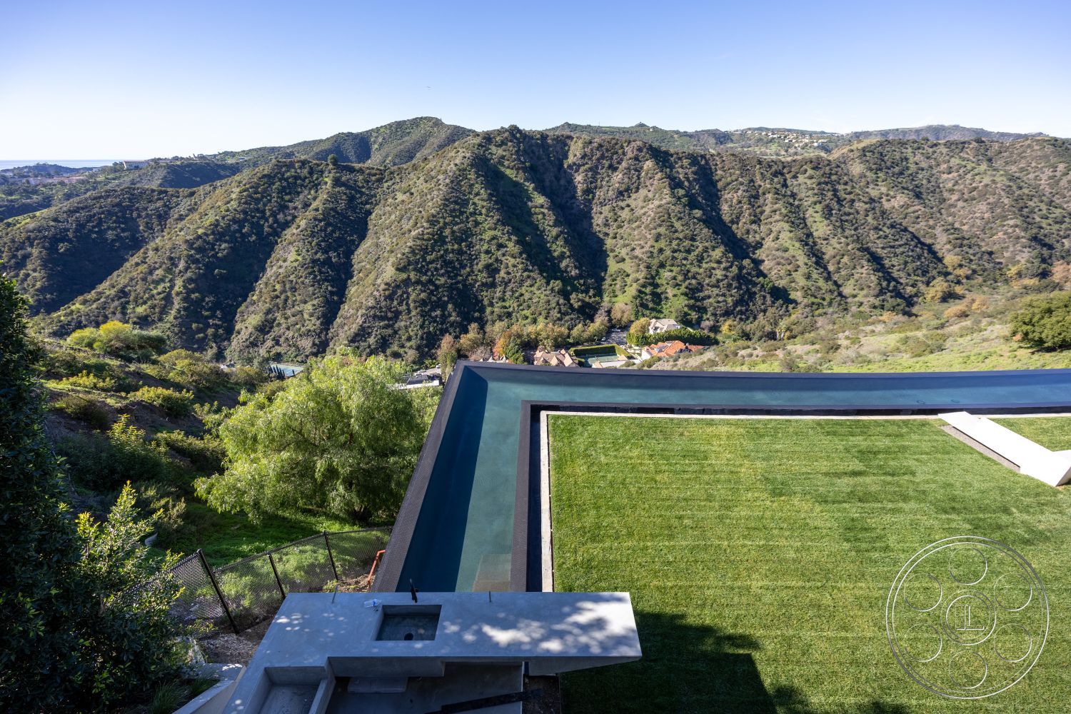 Modern 516 - exterior, landscaped garden, modern architecture, minimalist aesthetic, floor-to-ceiling windows, grass lawn, geometric shapes, infinity pool, stainless steel railing, outdoor living area, sloping hillside, surrounding mountains, concrete pool border, urban hillside, open landscape view