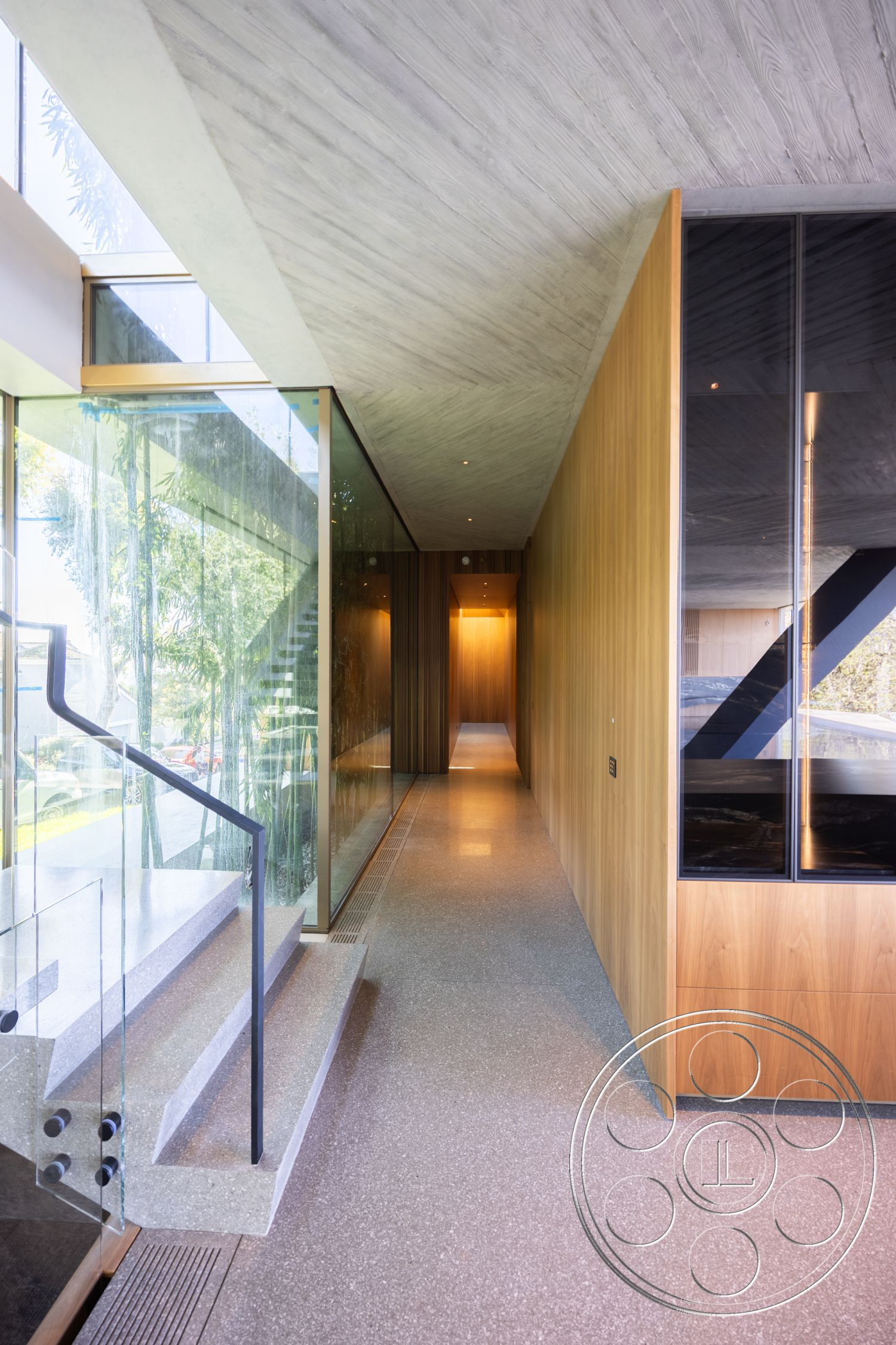 Modern 516 - indoor-outdoor flow, custom cabinetry, exposed concrete walls, floor-to-ceiling windows, modern architectural style, architectural features, interior recessed lighting, open floor plan design, interior minimalist design, interior hallway design, interior terrazzo flooring, sustainable materials usage, natural light entry, exterior wooden paneling, interior concrete ceiling, exterior glass partition walls, interior floating stairs, glass railing stair detail, contemporary home environment