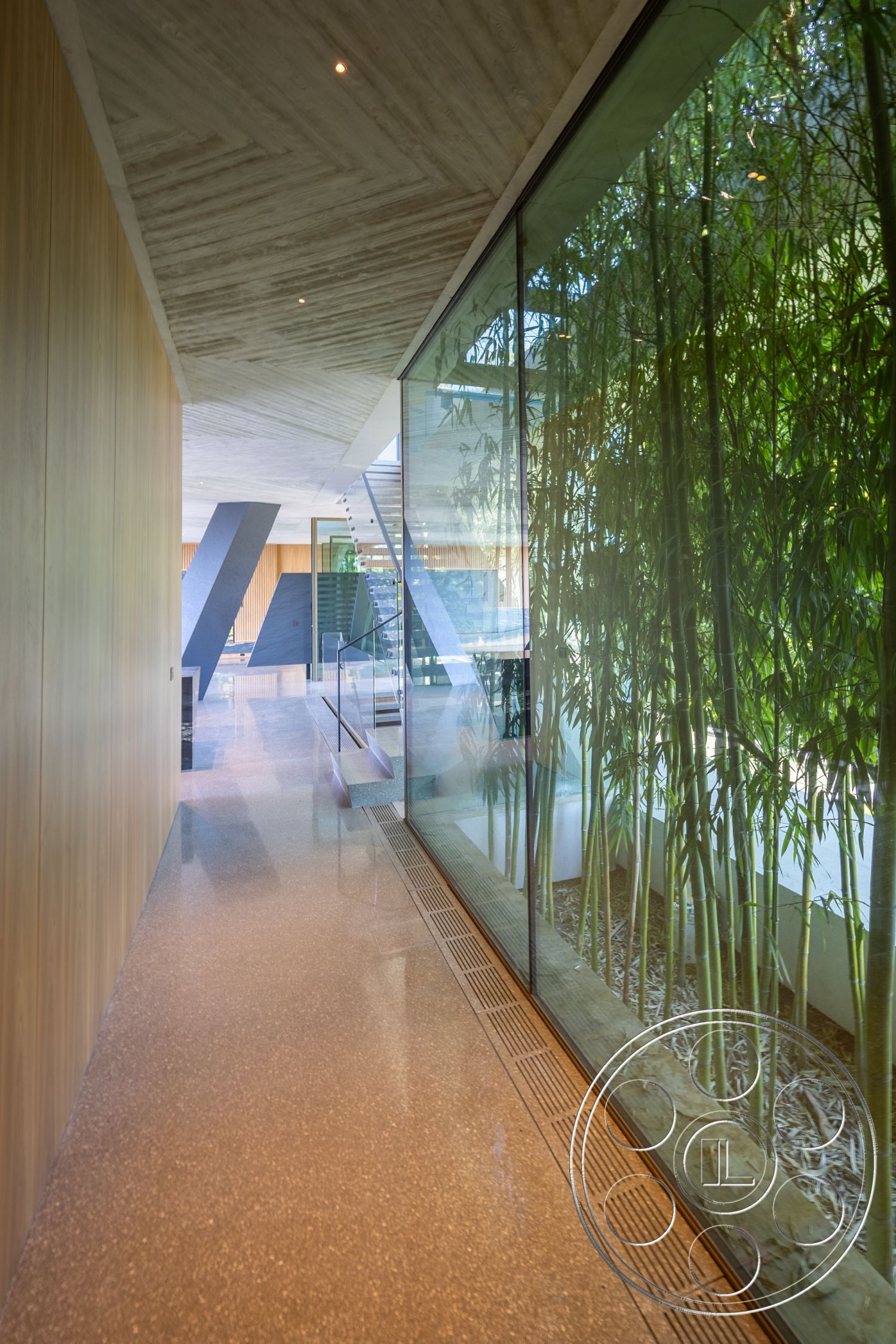 Modern 516 - polished concrete flooring, indoor-outdoor flow, floor-to-ceiling windows, contemporary architectural style, modern minimalist design, natural light interior, glass wall partition, open hallway layout, textured concrete ceiling, exposed wood paneling, stainless steel stair railing, integrated bamboo landscaping, linear drainage system, interior hallway space, greenery accent feature