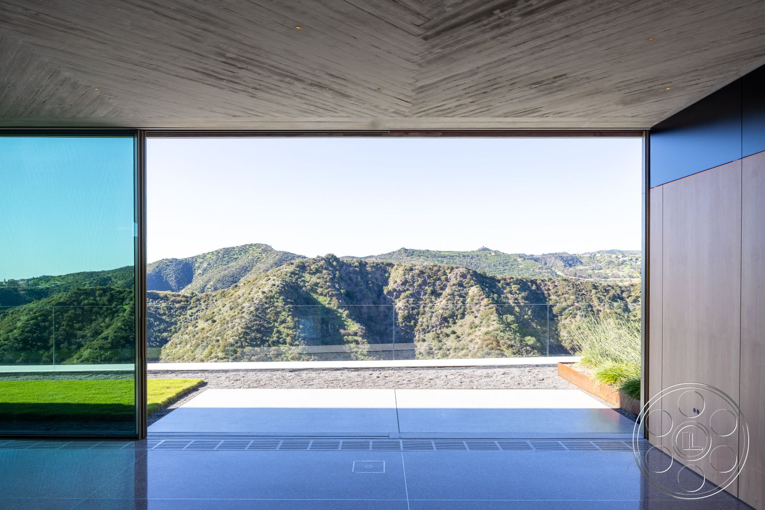 Modern 516 - natural light, polished concrete flooring, minimalist style, modern landscaping, exposed structural elements, wood panel wall, modern architectural design, glass floor-to-ceiling windows, rectangular outdoor terrace, concrete ceiling panels, urban minimalist aesthetic, landscape patio with gravel, hillside location with mountain view, interior living space with open concept, mountain cabin influence, outdoor glass railing, interior and exterior harmony