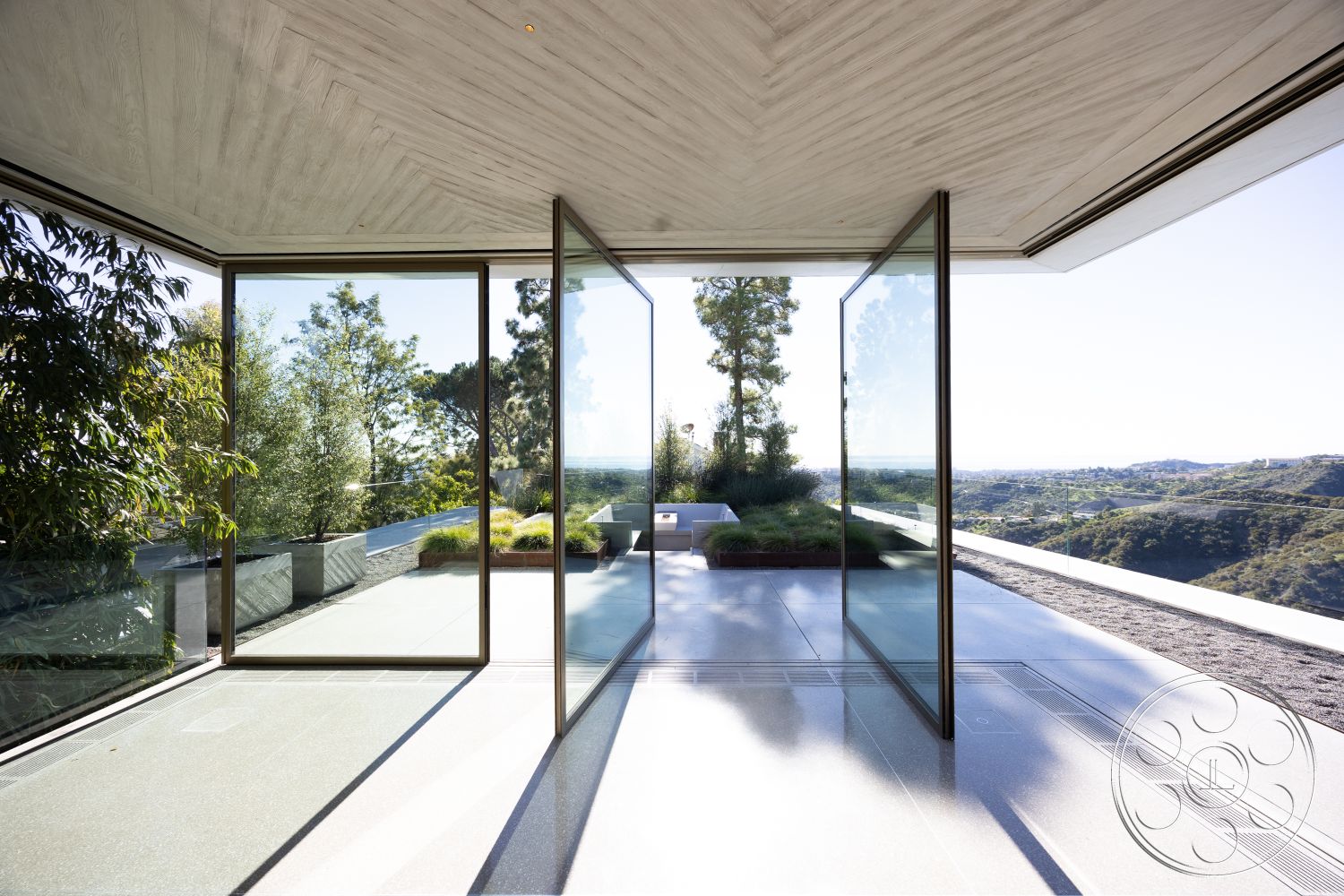 Modern 516 - open floor plan, floor-to-ceiling windows, exposed wood ceiling beams, glass partition walls, minimalist interior style, concrete patio floor, interior glass sliding doors, landscaped garden patio, modern architectural design, natural light filled space, polished concrete finish, exterior panoramic mountain view, sunlit living area, landscaped outdoor terrace