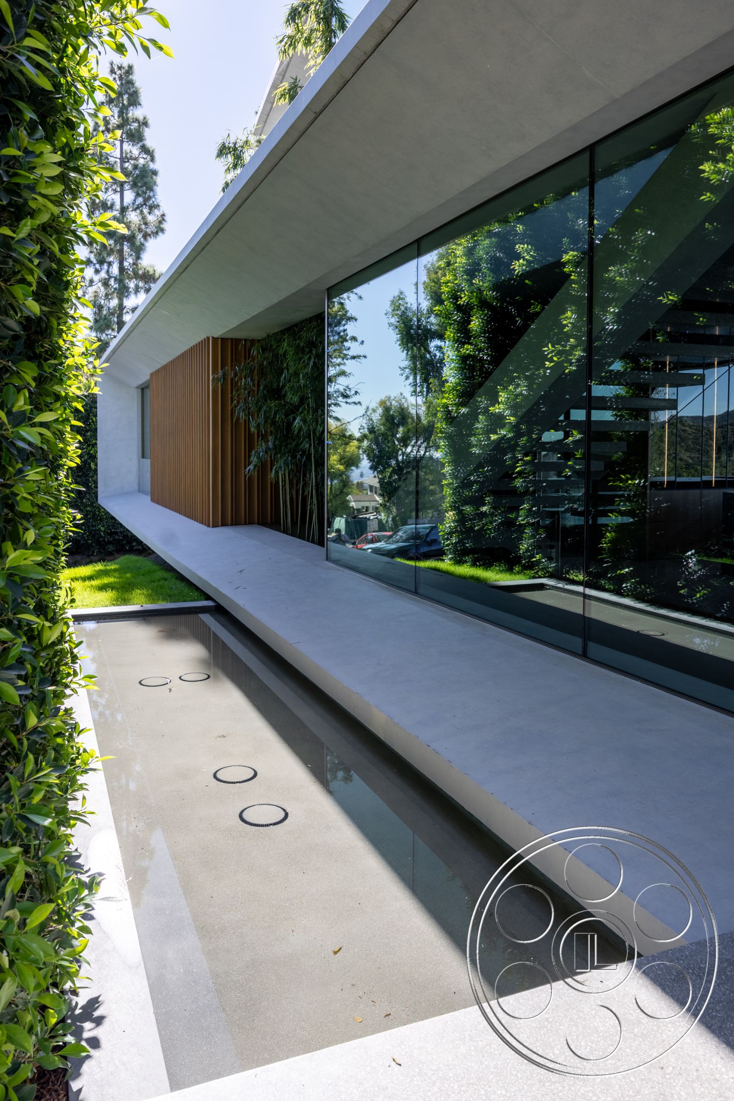 Modern 516 - minimalist design elements, modern architectural style, interior greenery, interior polished concrete flooring, interior floating staircase, surrounding urban environment, exterior glass wall, rectangular water feature, exterior concrete patio, exterior landscaped yard, exterior concrete overhang, exterior wooden slatted paneling, natural light infusing living areas