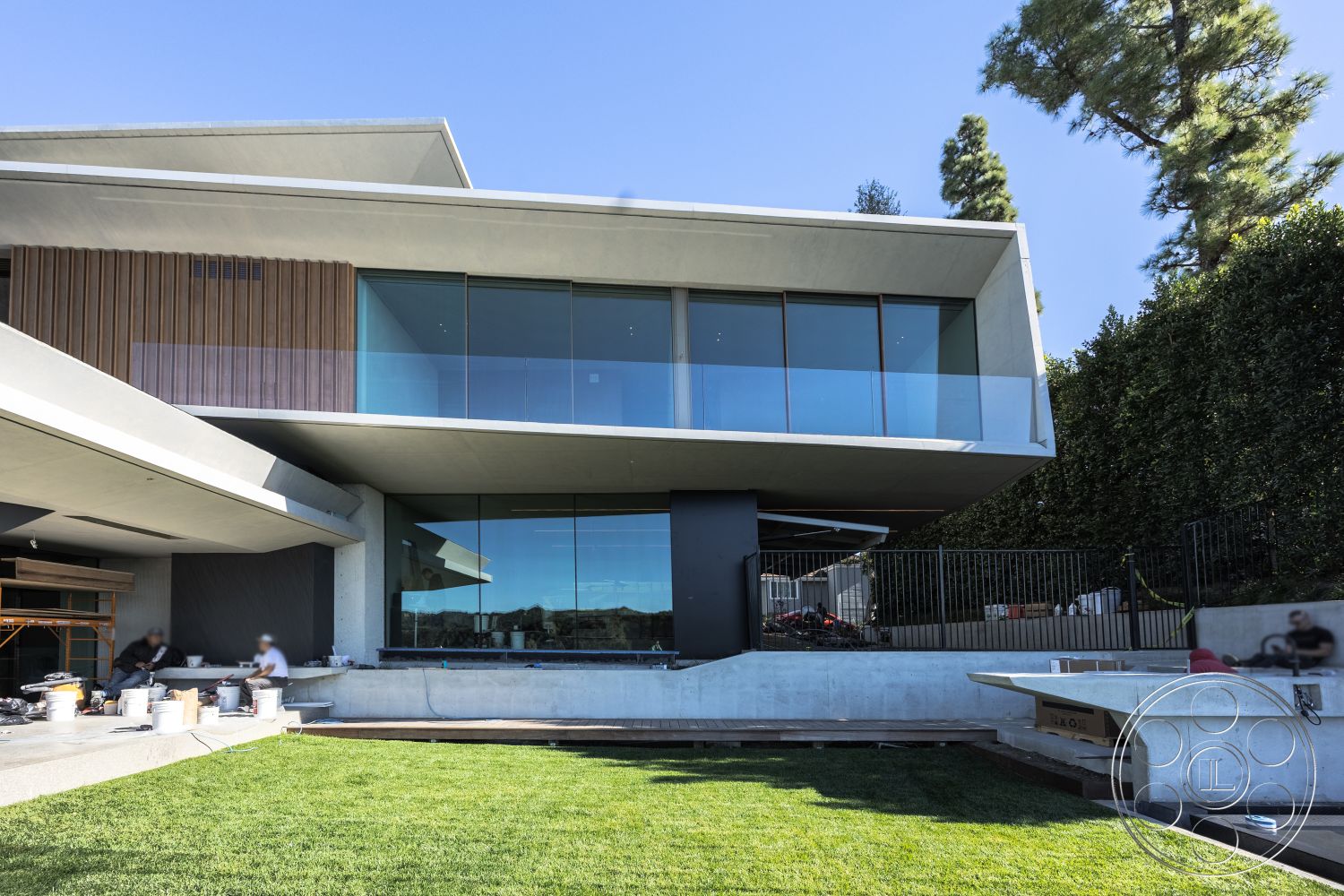 Modern 516 - minimalist design elements, large floor-to-ceiling windows, rectangular pool, flat roof design, contemporary architectural style, open floor plan layout, concrete pool border, exterior concrete walls, exterior glass railing, urban hillside setting, natural light flooding interior, exposed wood paneling, modern geometric shapes, landscaped lawn area, built-in outdoor seating area