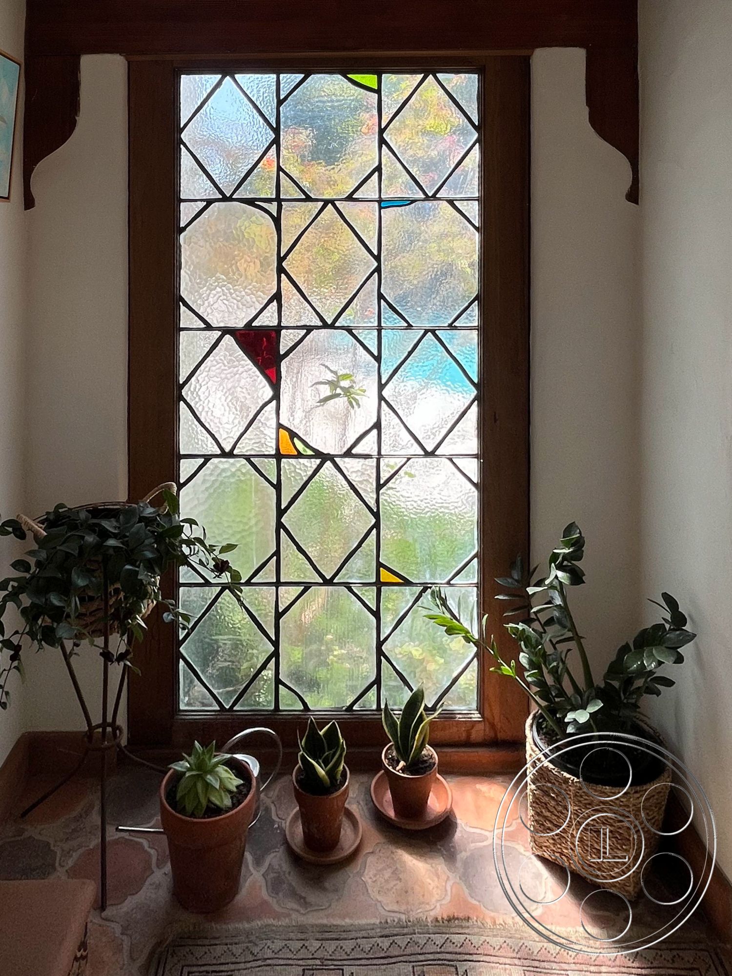 Medit 166 - decorative area rug interior, stained glass window interior, wood window frame interior, textured glass panel interior, potted plants on floor interior, rustic ceramic plant pots interior, natural stone flooring interior, woven basket plant holder interior, wood trim accents interior, bright indoor garden setting interior