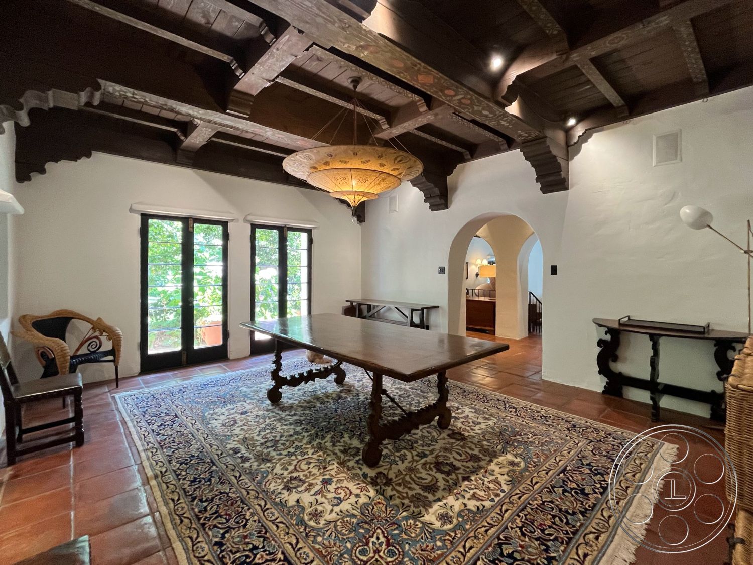 Medit 166 - exposed wood ceiling beams, interior, white painted walls, interior, textured plaster walls, interior, terra cotta tile flooring, interior, wood dining table, interior, black wrought iron light fixture, interior, arched doorways, interior, large windows with black frames, interior, traditional area rug, interior, wooden side chairs, interior, Spanish-style architectural details, interior, built-in features, interior, open layout, interior