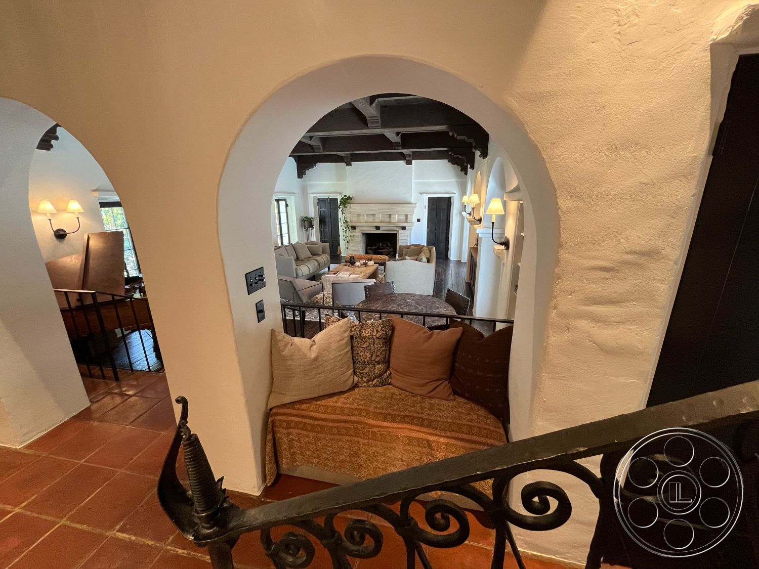 Medit 166 - plush sectional sofa, textured throw pillows, open concept living space, arched doorways, Spanish-style architecture, decorative wall sconces, cozy reading nook, rustic wood coffee table, plaster wall finish, exposed wood ceiling beams, natural light through windows, vaulted living room ceiling, terra-cotta tile flooring, layered area rug, built-in fireplace mantel, intricate wrought iron railing, soft earth-tone color palette, comfortable family room, artistic decorative accents