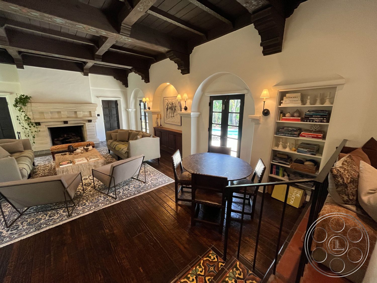 Medit 166 - cozy living room interior, exposed wood ceiling beams interior, light-colored walls interior, textured plaster walls interior, natural light from windows interior, decorative area rug interior, round dining table interior, arched doorways interior, modern rustic style interior, wooden coffee table interior, stone fireplace wall interior, dark hardwood living room floors interior, farmhouse dining area interior, built-in bookshelves interior, fabric armchairs interior, indoor plants interior, pool view from living area interior, Moorish architectural details interior, wooden staircase railings interior, stylish decor accessories interior