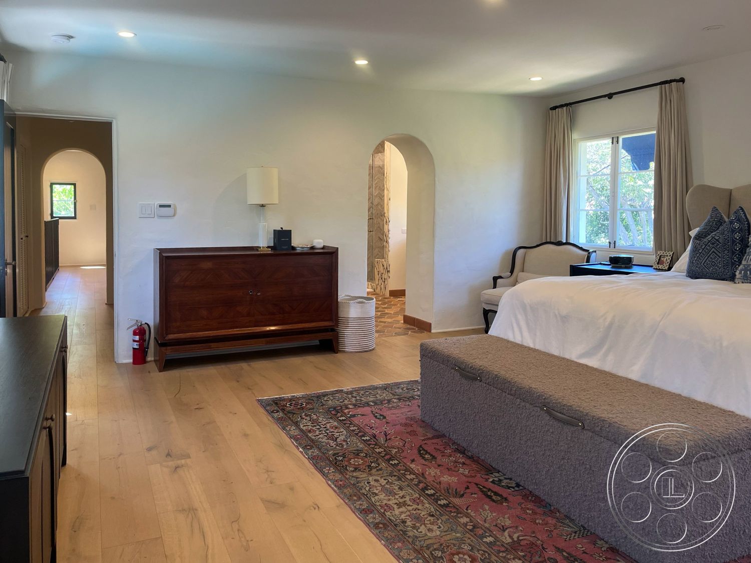 Medit 166 - neutral color palette, decorative area rug, floor-to-ceiling windows, soft curtains, wooden nightstand, arched doorways, textured plaster walls, cozy reading nook, luxurious bedding, hardwood bedroom floors, wood beam ceiling, white painted walls, modern accent decor, traditional bedroom furniture