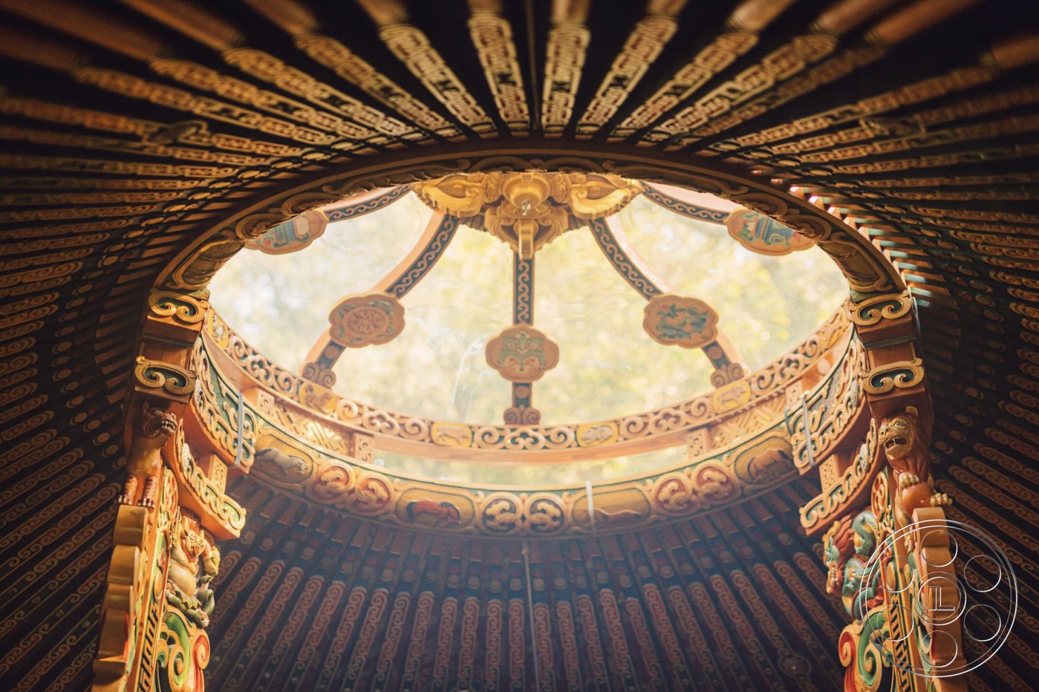 Topanga Retreat - vibrant color palette, natural light flooding interior, circular skylight opening, traditional yurt interior, woven textile wall hangings, decorative wooden ceiling beams, ornate hand-carved wooden details, painted wooden wall accents, symmetrical geometric patterns, eco-friendly sustainable materials, interior design with cultural influences, artisan craftsmanship features, nostalgic rustic charm, whimsical decorative motifs, rounded wall structure, integrated seating areas, outdoor-inspired interior aesthetics, traditional craftsmanship elements, intimate and cozy atmosphere, interior space with ceiling height variation