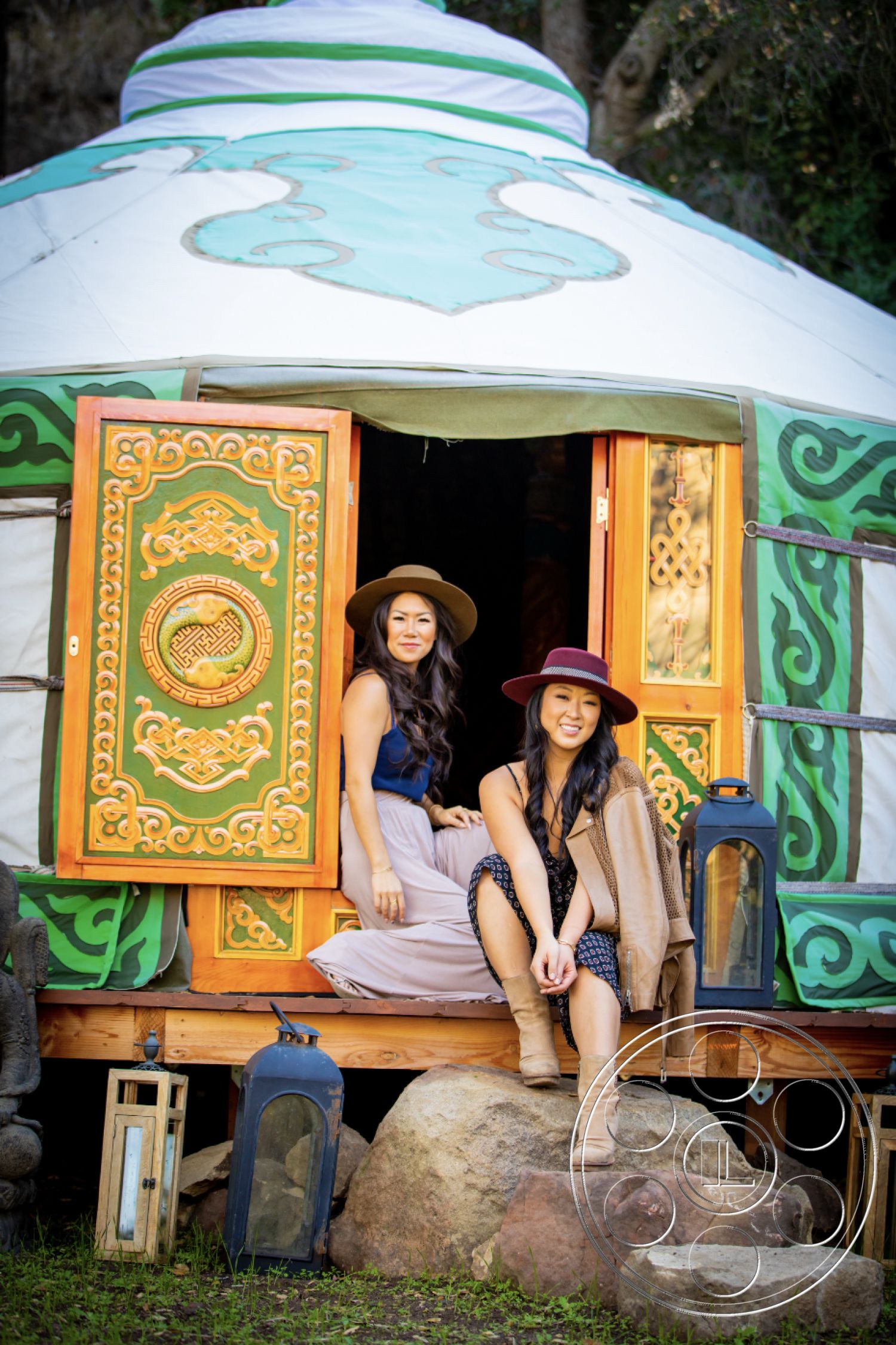 Topanga Retreat - surrounding greenery, traditional architecture, natural stone steps, landscaped garden setting, wooden deck flooring, wooden door frame, decorative wood paneling, cozy outdoor seating area, outdoor lantern fixtures, natural rock formations, yurt exterior, colorful painted details, circular ceiling structure, rural location, curved roof lines, ornate door carvings